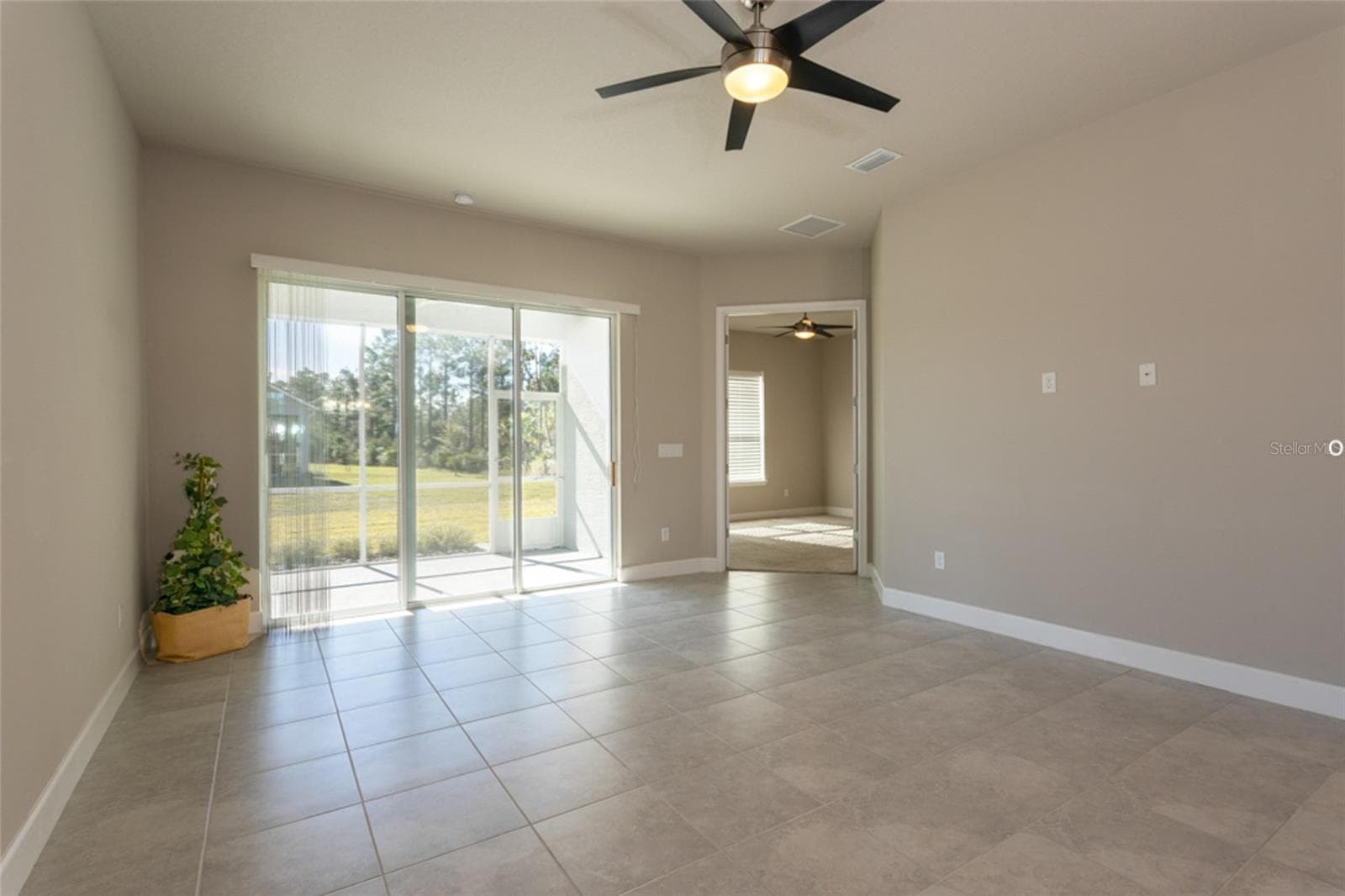 Living area looking towards lanai and primary bedroom - 3 NEWHAVEN LN, ORMOND BEACH