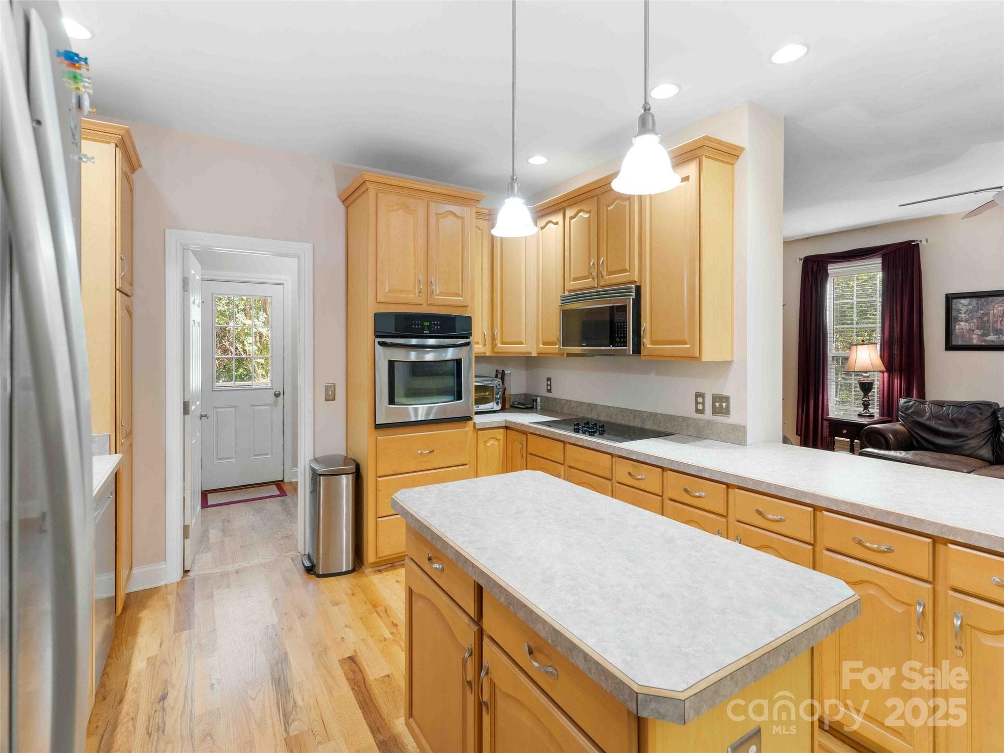 Bright kitchen with ample cabinetry and workspace for daily living and entertaining. - Pisgah Forest