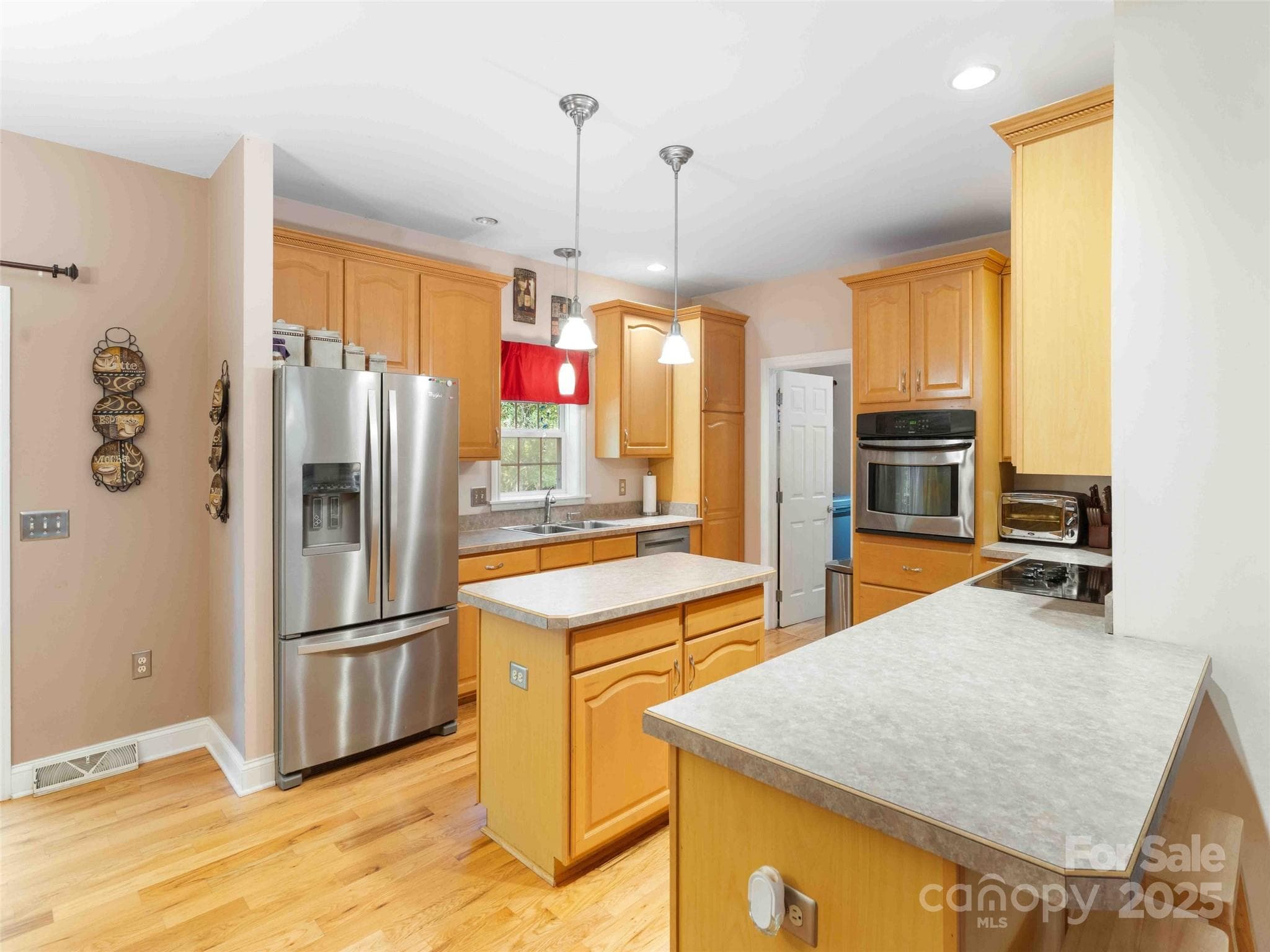 Bright kitchen with ample cabinetry and workspace for daily living and entertaining. - Pisgah Forest