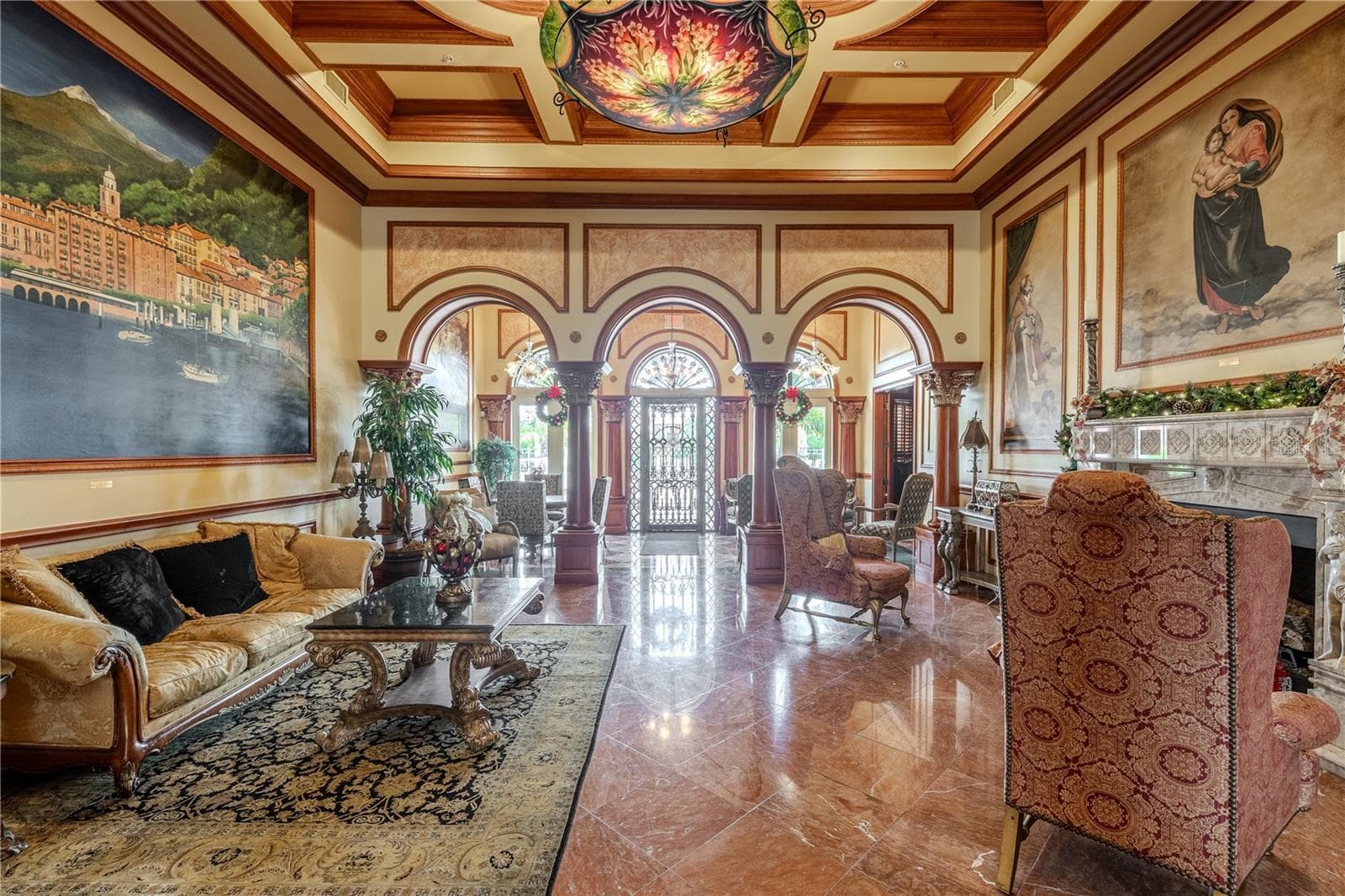Grand clubhouse lounge with soaring coffered ceilings, dramatic murals and arched columns, gleaming marble floors, and an elegant fireplace seating area that creates a truly resort-style welcome. - 2738 VIA TIVOLI #220B, CLEARWATER