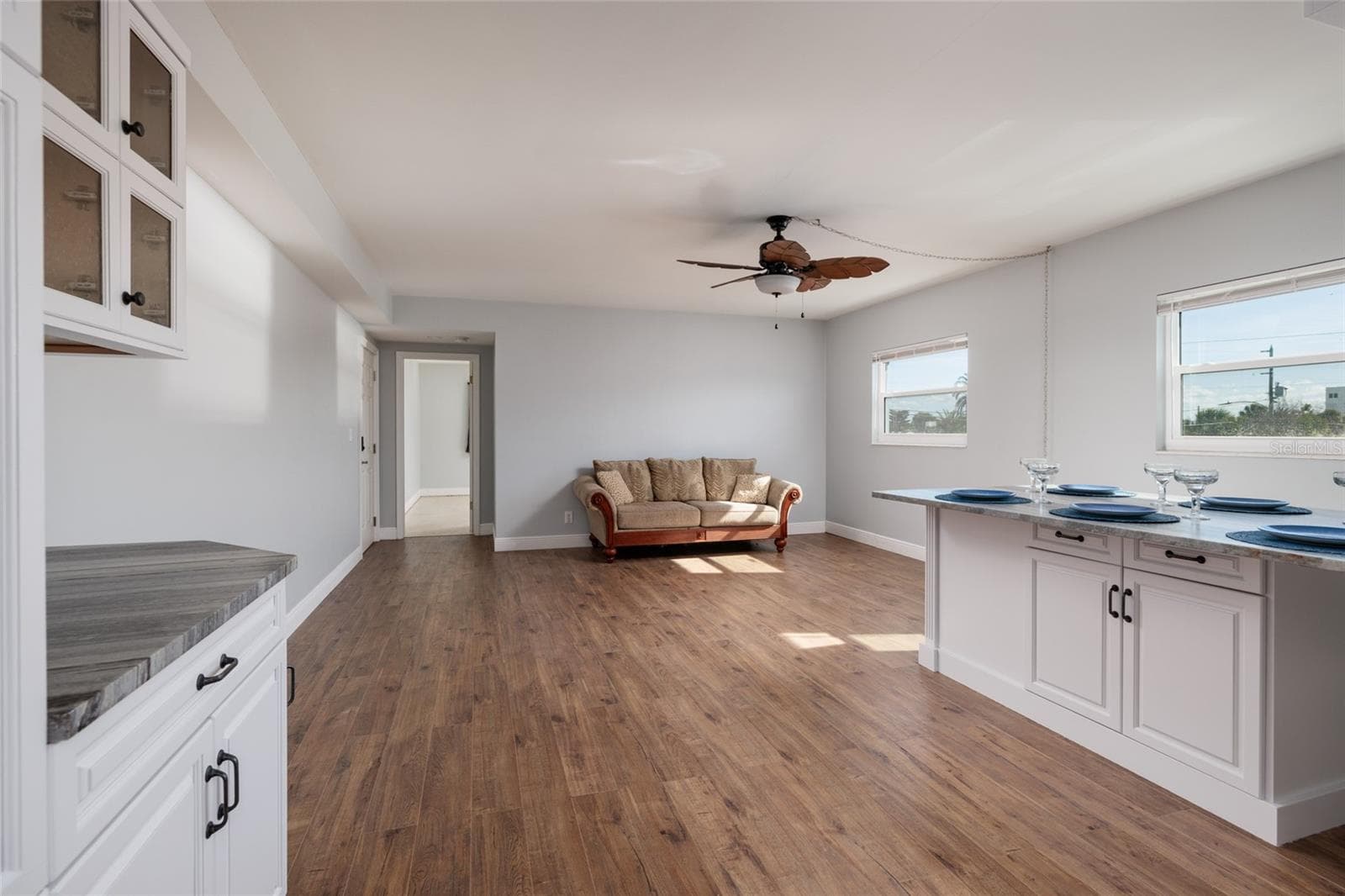 Dining/Living areas. Hurricane impact double pane windows. Doorway to primary bedroom. - 6000 2ND ST E #6, ST PETE BEACH