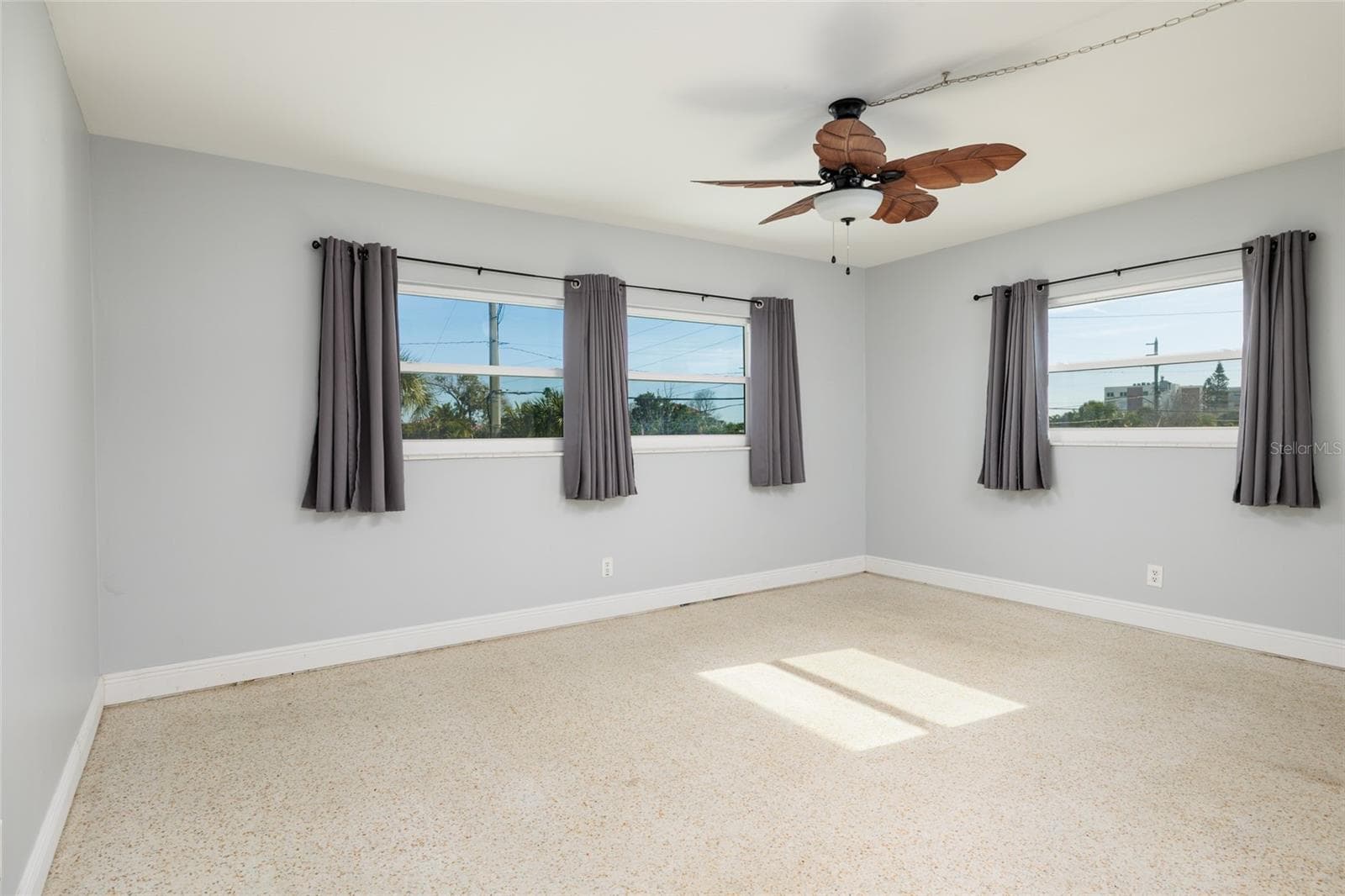 Front primary bedroom (16'x12') w/Hurricane impact double pane windows. Split bedrooms. En-suite bathroom & walk-in closet. - 6000 2ND ST E #6, ST PETE BEACH