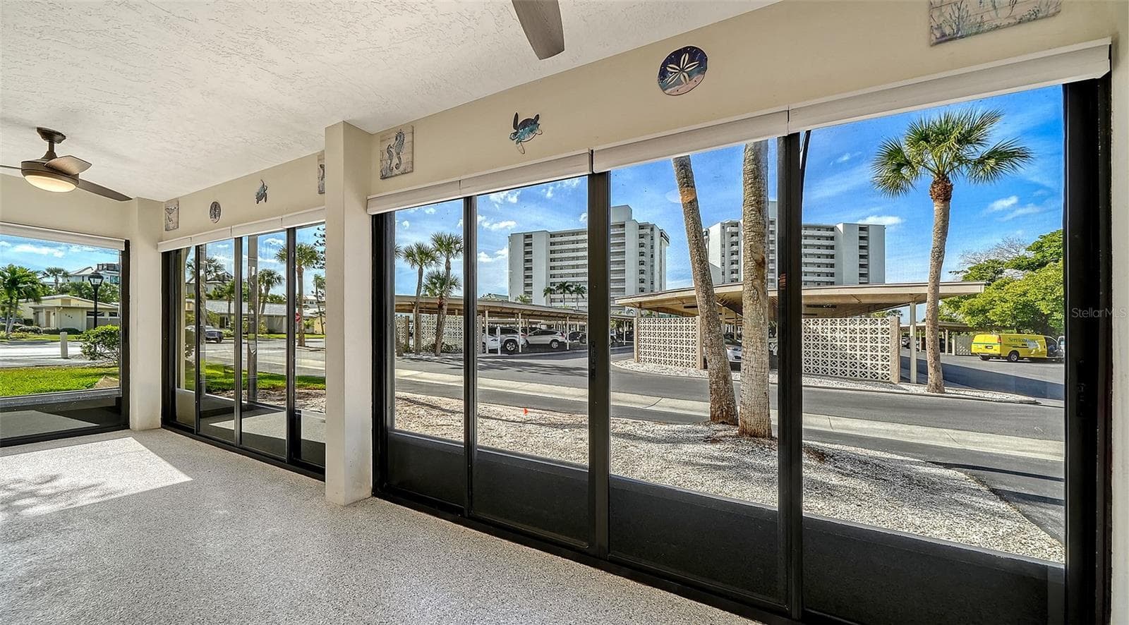 Sunny west facing screened and glassed Lanai #1 with epoxy floor and new ceiling fans. - 101 WHISPERING SANDS DR #107, SARASOTA
