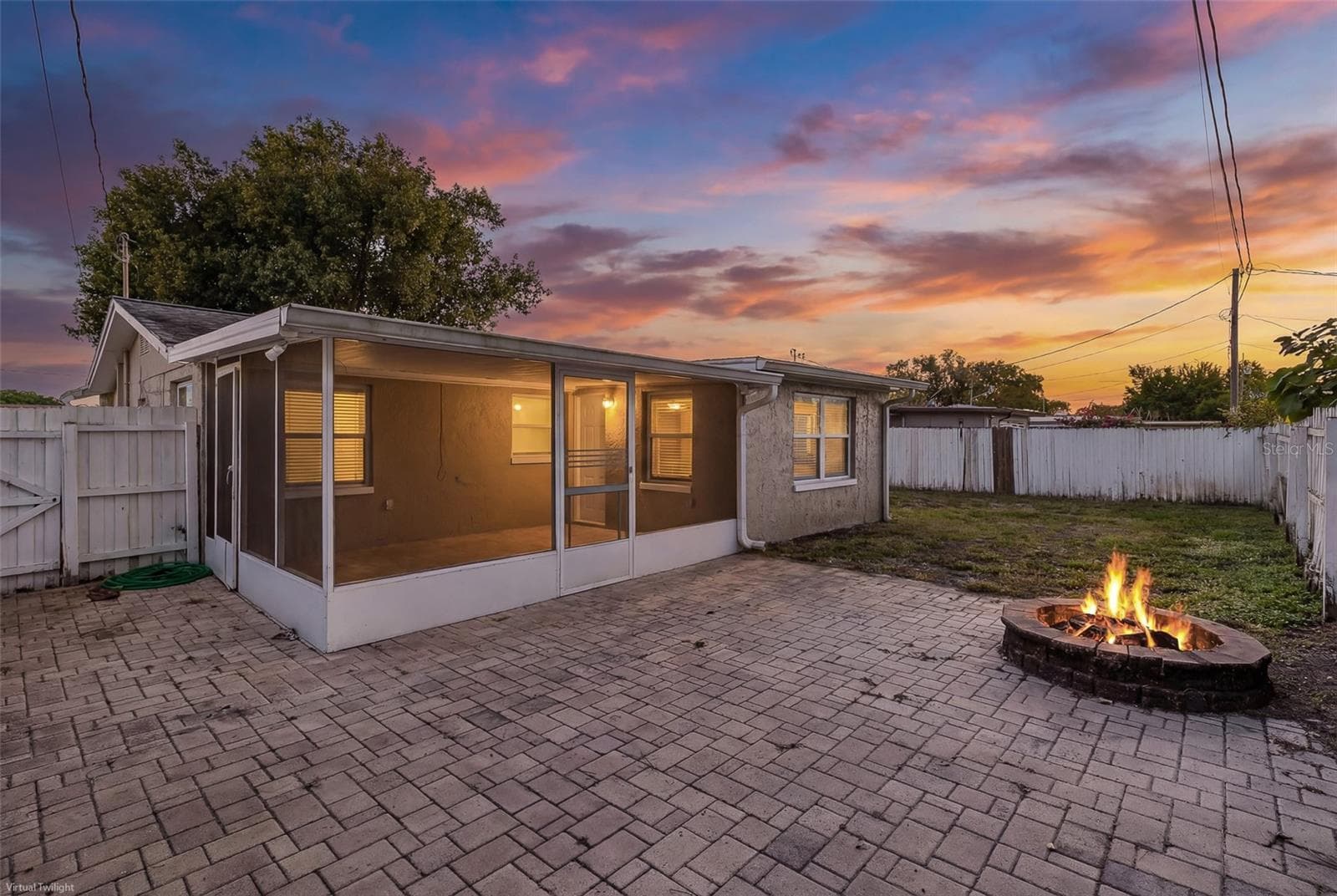 Pavers in Backyard with Firepit - 1148 FERNWOOD DR, HOLIDAY