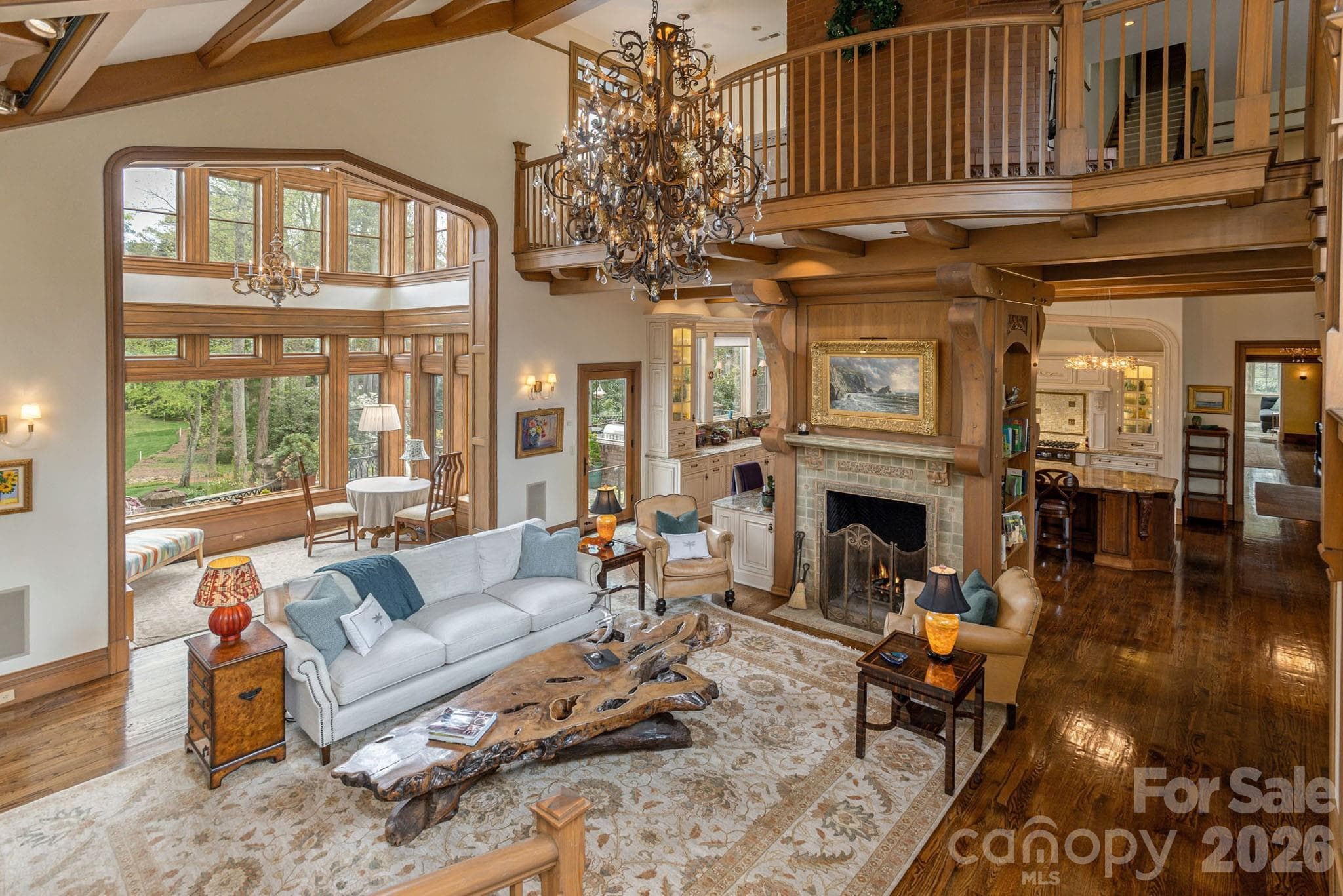 The family room opens onto a balcony that overlooks the great hall below, offering a stunning vantage point. - 8 Fairway Place, Asheville