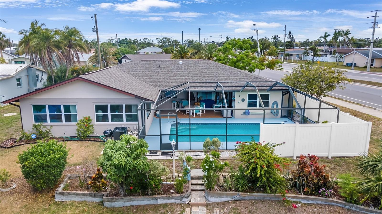 Rear home, new screened enclosure, new privacy fence around north side of pool and yard - 2132 ABSCOTT ST, PORT CHARLOTTE