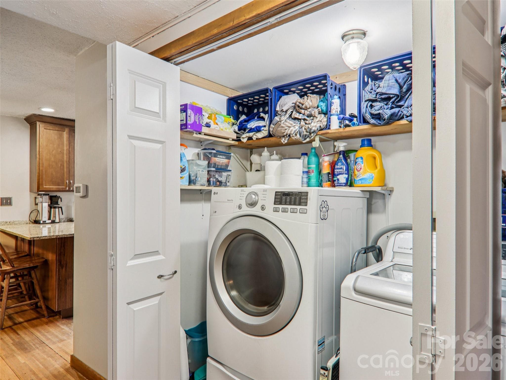 Laundry area conveniently located off the kitchen, with shelving for storage and easy everyday access - 7 Landon Mountain Lane, Weaverville