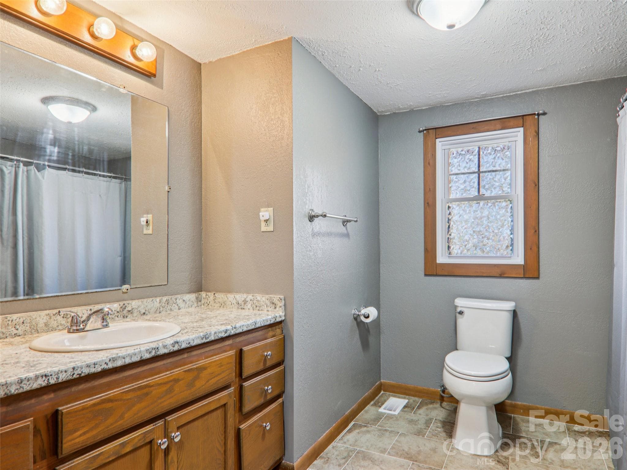 Second full bathroom with granite vanity top, wood cabinetry, and a tub/shower combination - 7 Landon Mountain Lane, Weaverville
