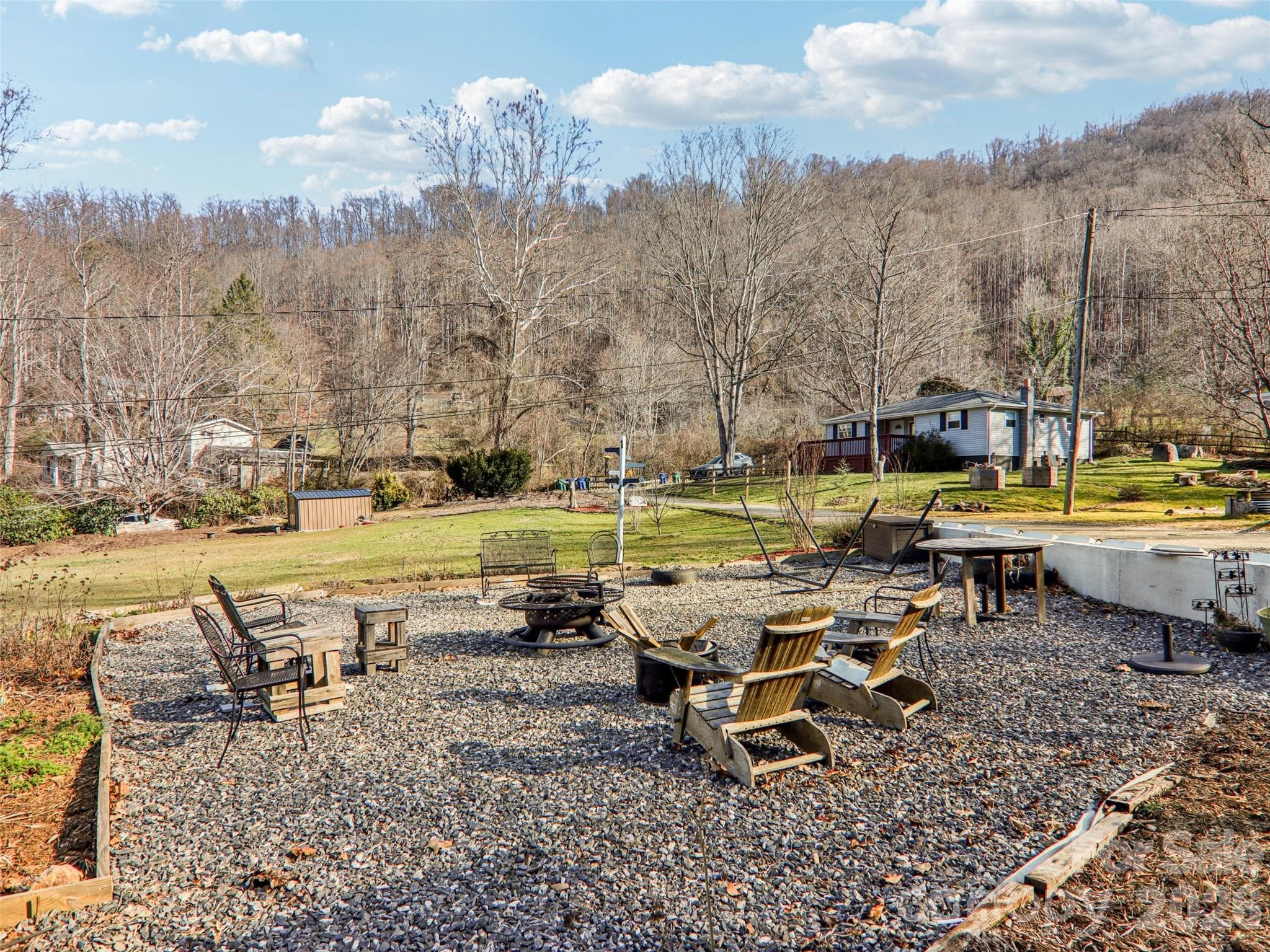 Outdoor gravel seating area with space for gathering and enjoying the surrounding yard and mountain backdrop - 7 Landon Mountain Lane, Weaverville