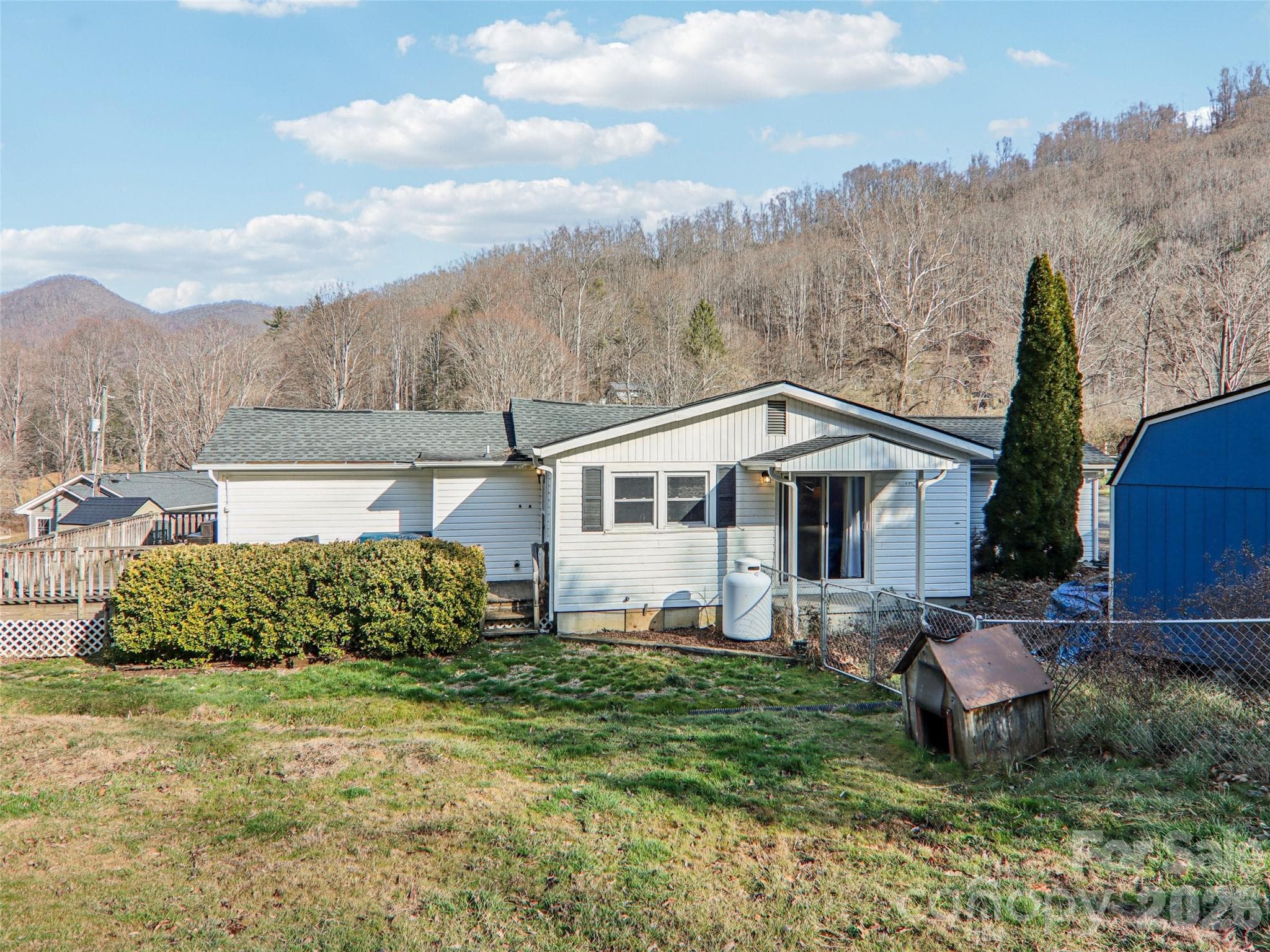 Rear view of the home with yard and storage shed - 7 Landon Mountain Lane, Weaverville