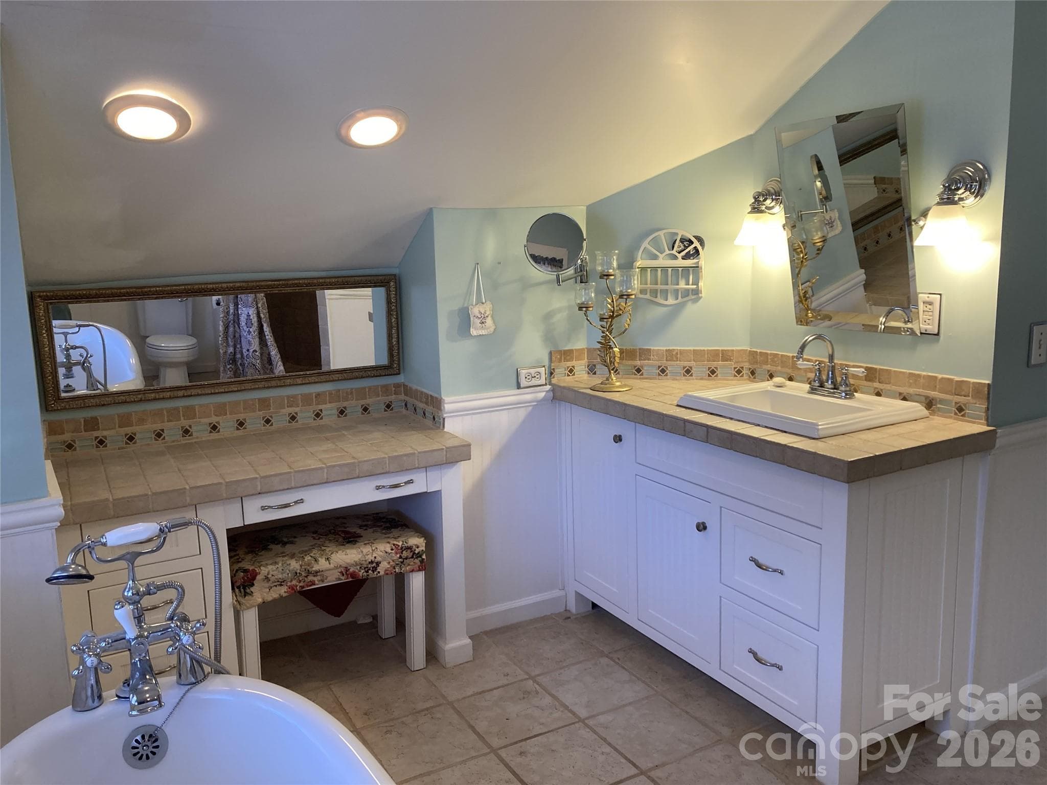 Upper level en-suite primary bath has a tiled shower. - 1051 Pee Dee Avenue, Albemarle
