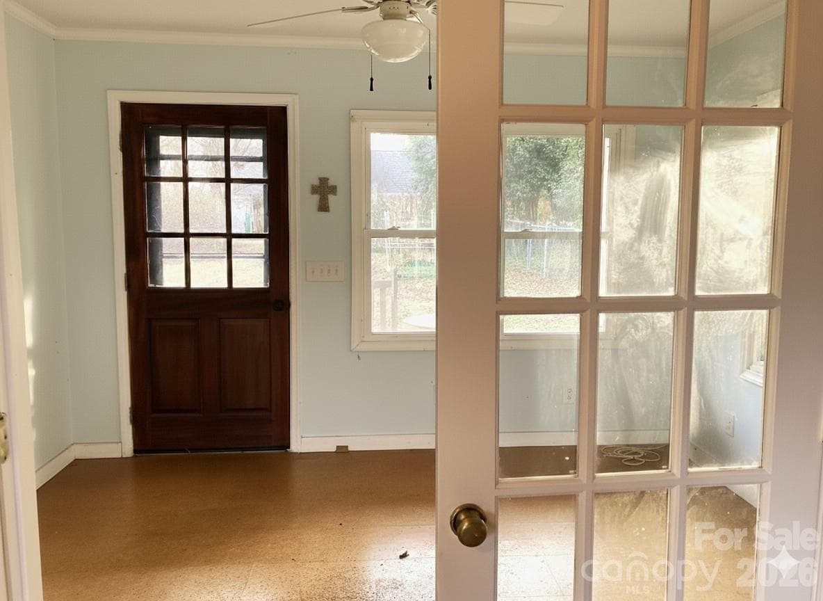 French doors separate a larger flex space from small living space with kitchen sink and lower cabinets. - 1051 Pee Dee Avenue, Albemarle