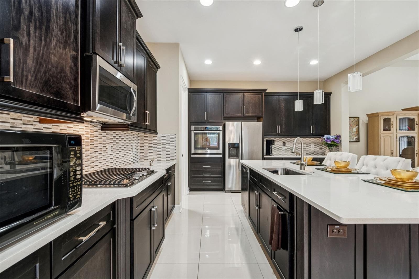 Well-appointed kitchen with quartz countertops, stainless steel appliances, and oversized island - 4155 BARLETTA CT, WESLEY CHAPEL
