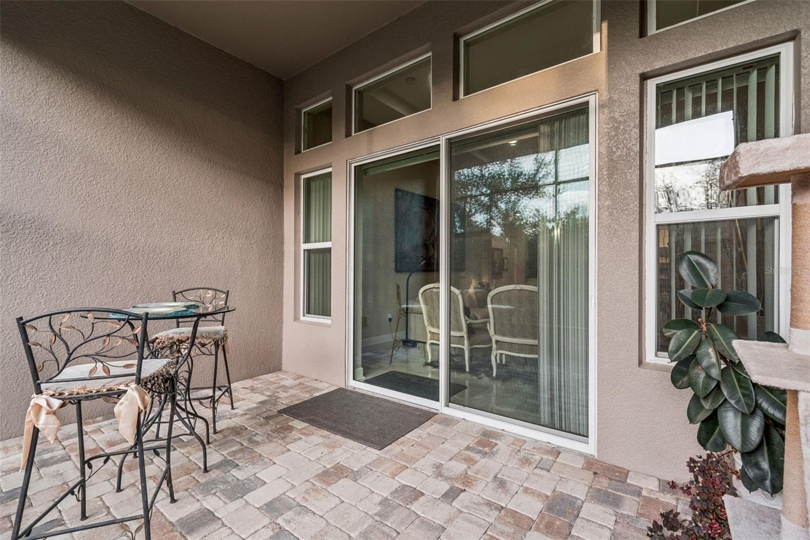 Private pavered screened-in patio with access to the fenced backyard - 4155 BARLETTA CT, WESLEY CHAPEL