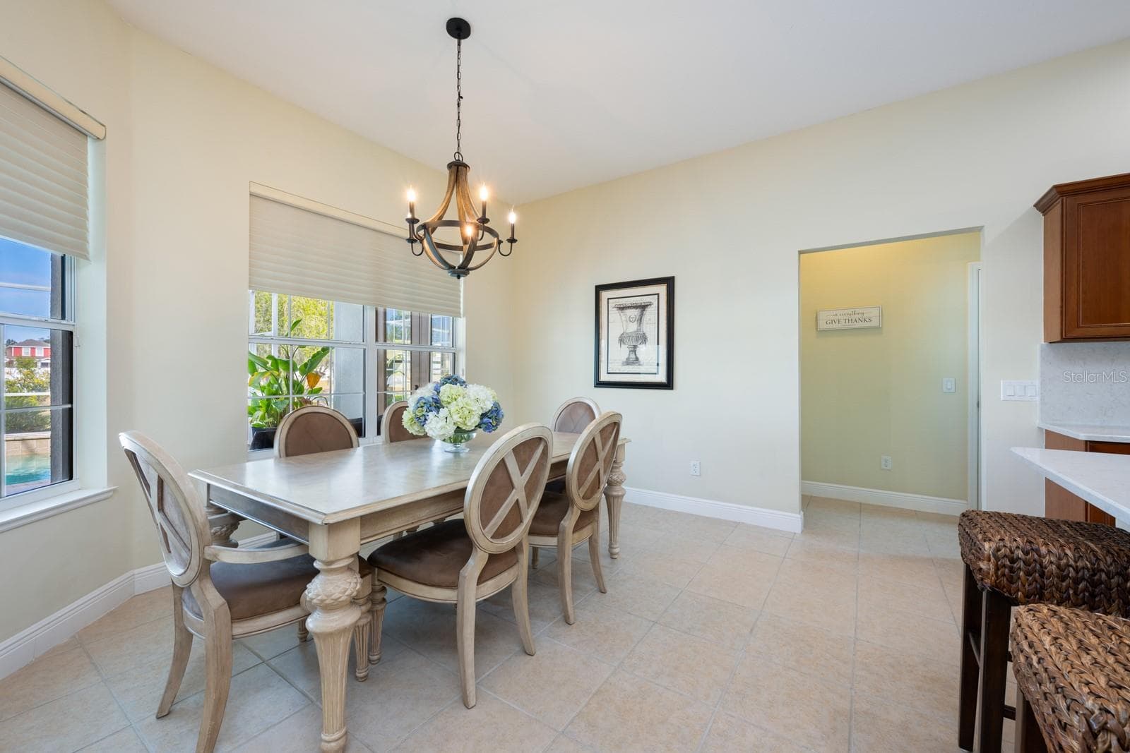 Light filled casual dining with a view of the pool. - 5092 NE 81ST BLVD, WILDWOOD