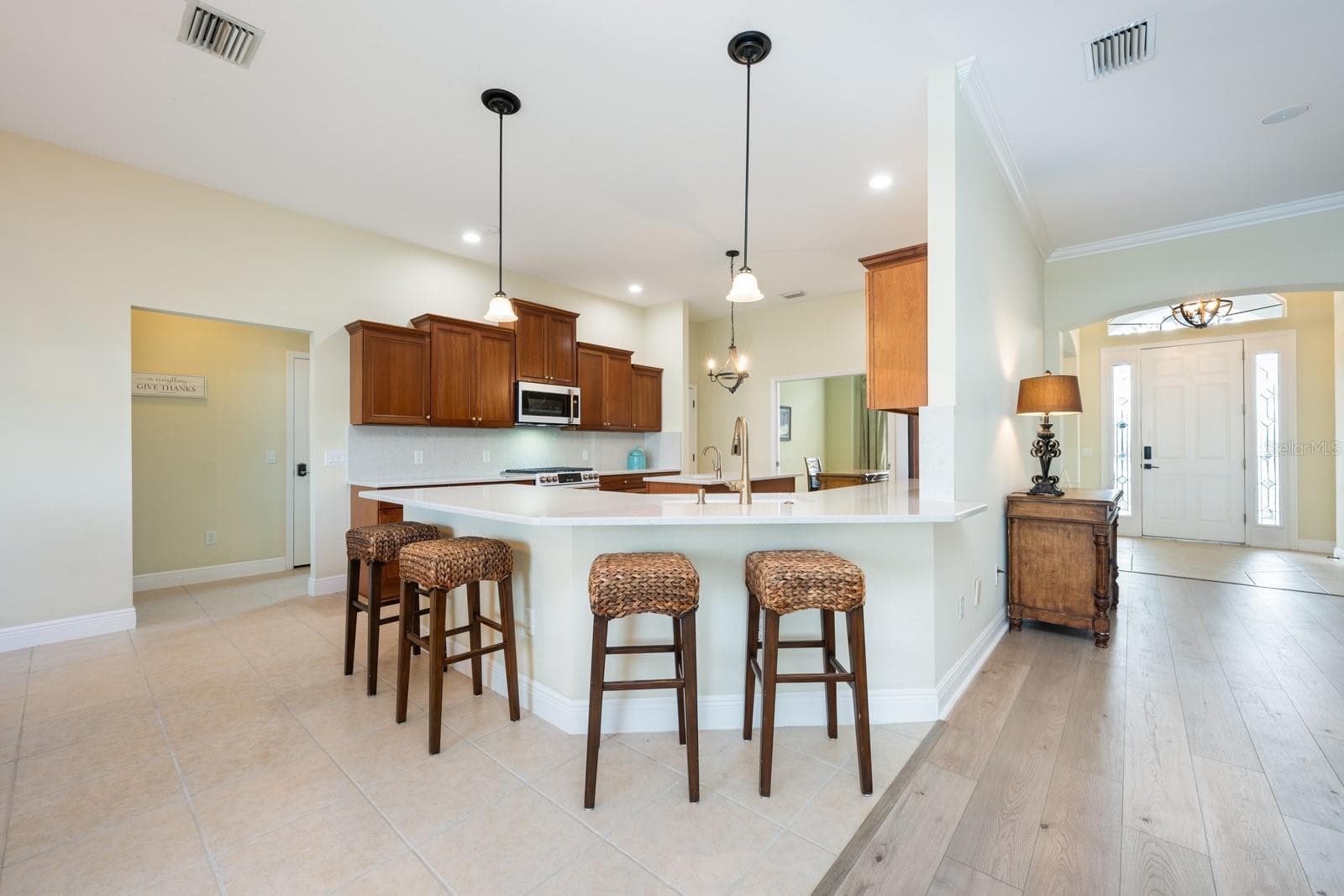Inside, over 3,400 square feet of curated living space unfolds with high-end finishes, CERAMIC TILE and LUXURY VINYL PLANK FLOORING throughout, flexible formal areas, and an open, inviting family room that flows seamlessly into a light-filled breakfast nook and a timeless kitchen with a modern edge – perfect for any style! - 5092 NE 81ST BLVD, WILDWOOD