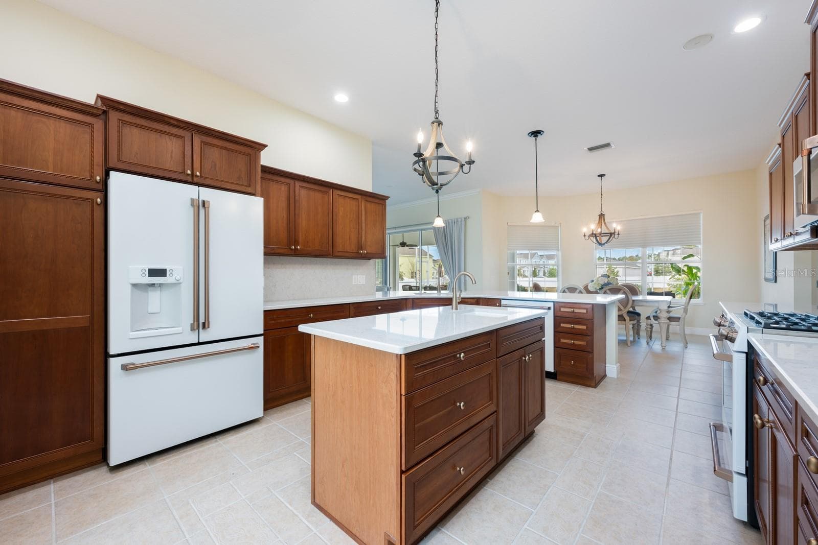 The home chef’s dream kitchen features sleek CULTURED GRANITE COUNTERTOPS, an ISLAND with prep sink, and NEW GE CAFE APPLIANCES, ideally suited for both everyday living and entertaining with ease. - 5092 NE 81ST BLVD, WILDWOOD