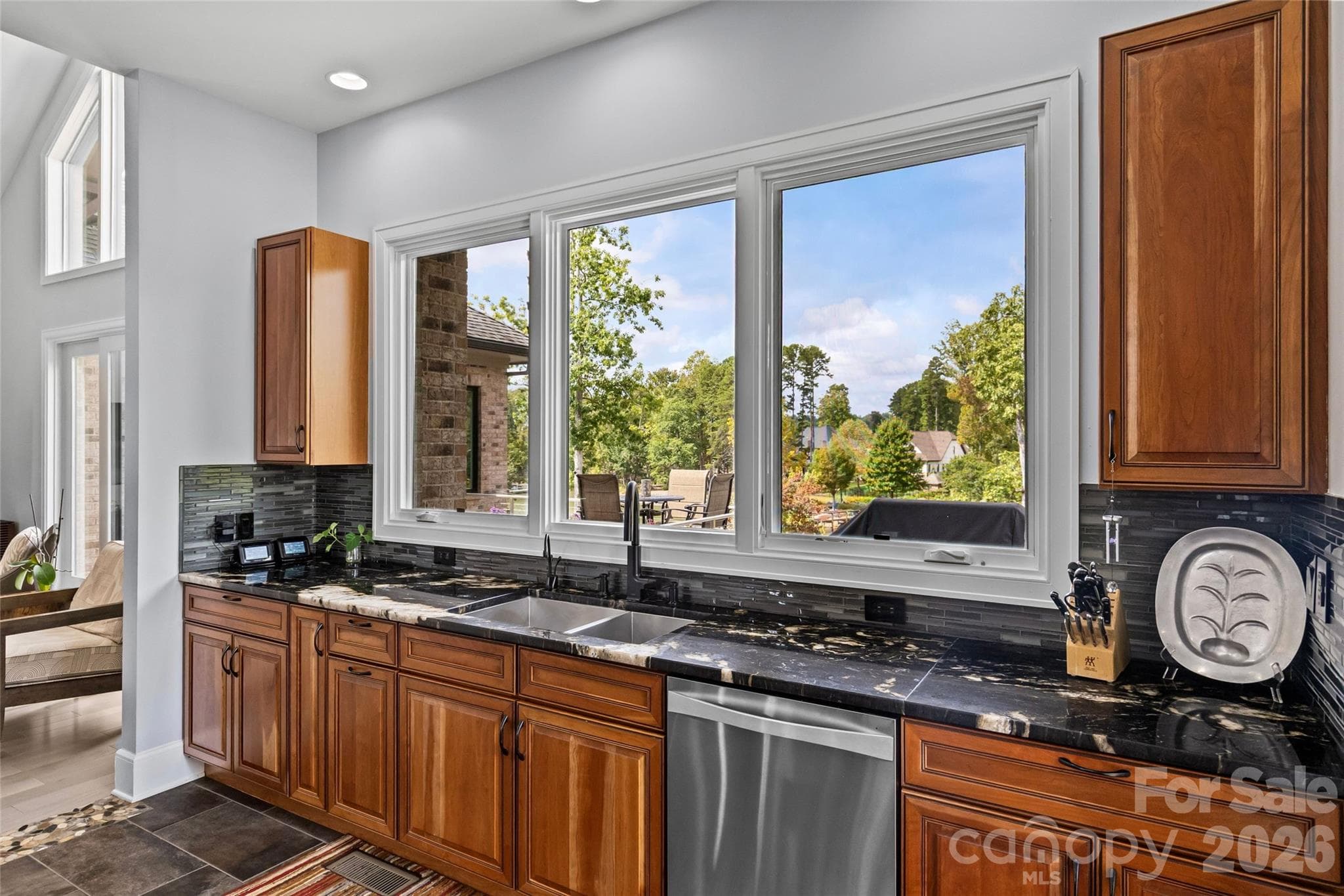 Stunning chef's kitchen has cherry & maple cabinets, granite countertops, oversized kitchen island, dual built-in stainless steel Frigidaire refrigerator & freezer, stainless steel appliances, prep sink in kitchen island with disposal, large butlers pantry with additional sink & dishwasher, & bar with ice maker. - 6032 Headlands Court, Belmont