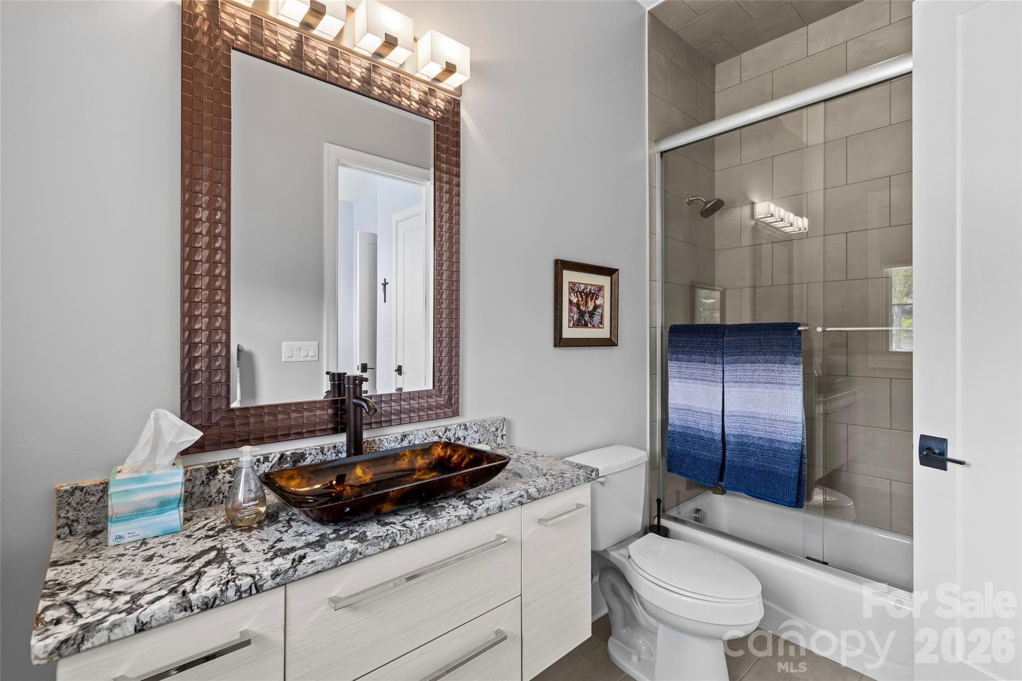Secondary bedroom on main level with en suite full bathroom. - 6032 Headlands Court, Belmont