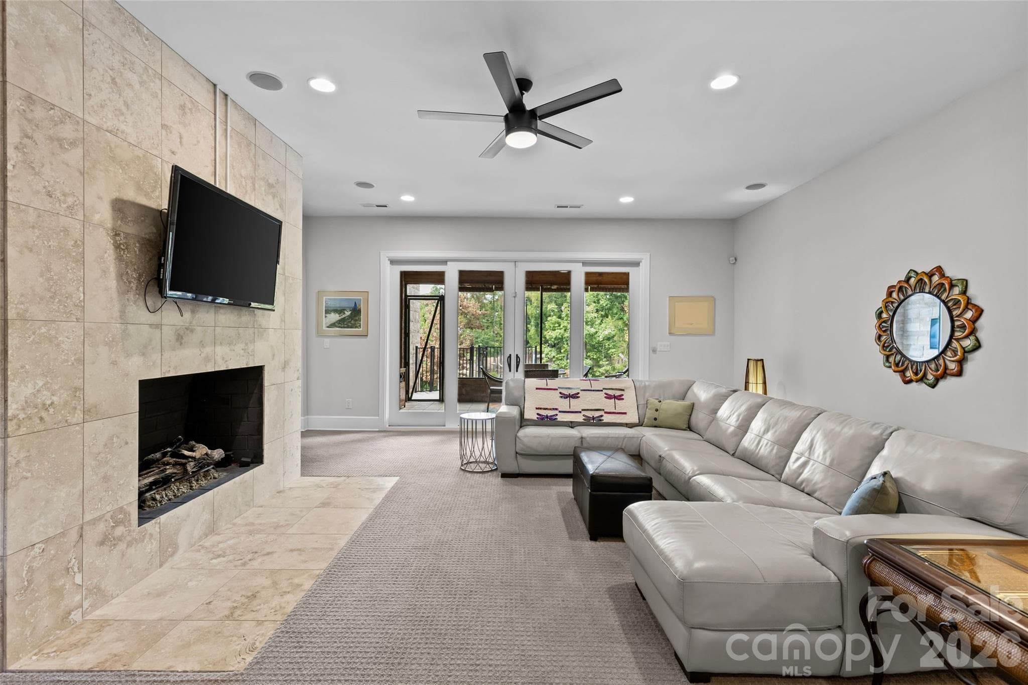 Lower level features an oversized family room with gas fireplace, 3 bedrooms, 2 full bathrooms, incredible walk in storage & sliding door access to the screened in porch. - 6032 Headlands Court, Belmont
