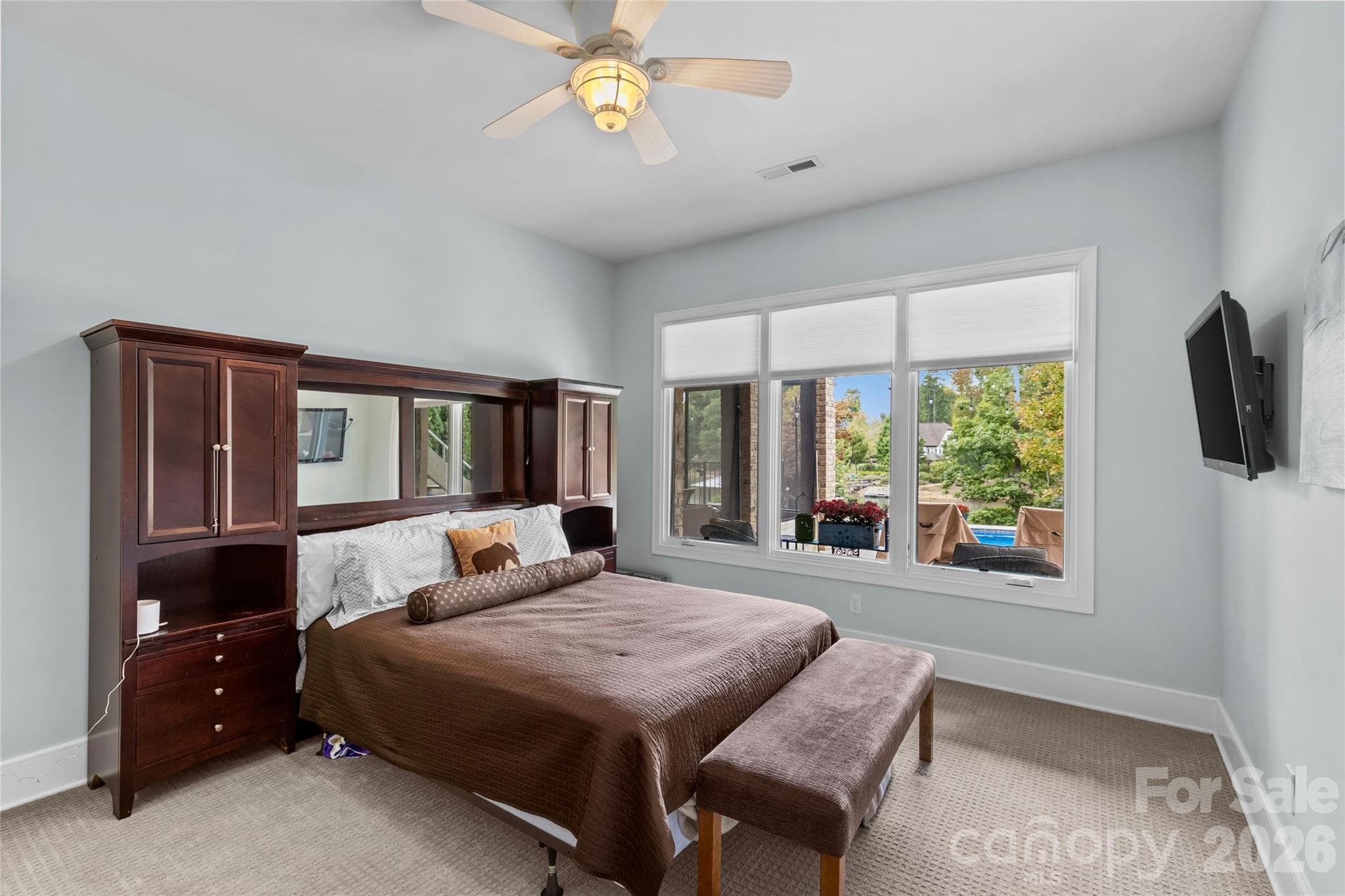 Lower level features an oversized family room with gas fireplace, 3 bedrooms, 2 full bathrooms, incredible walk in storage & sliding door access to the screened in porch. - 6032 Headlands Court, Belmont