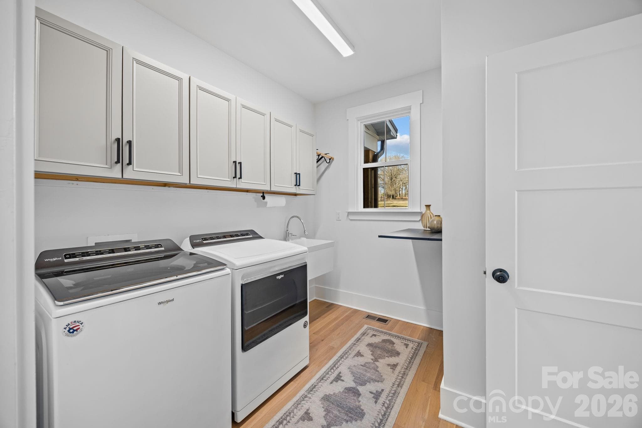 Spacious laundry room- sink, storage- located right outside Primary on main level - 5020 Slanting Bridge Road, Sherrills Ford