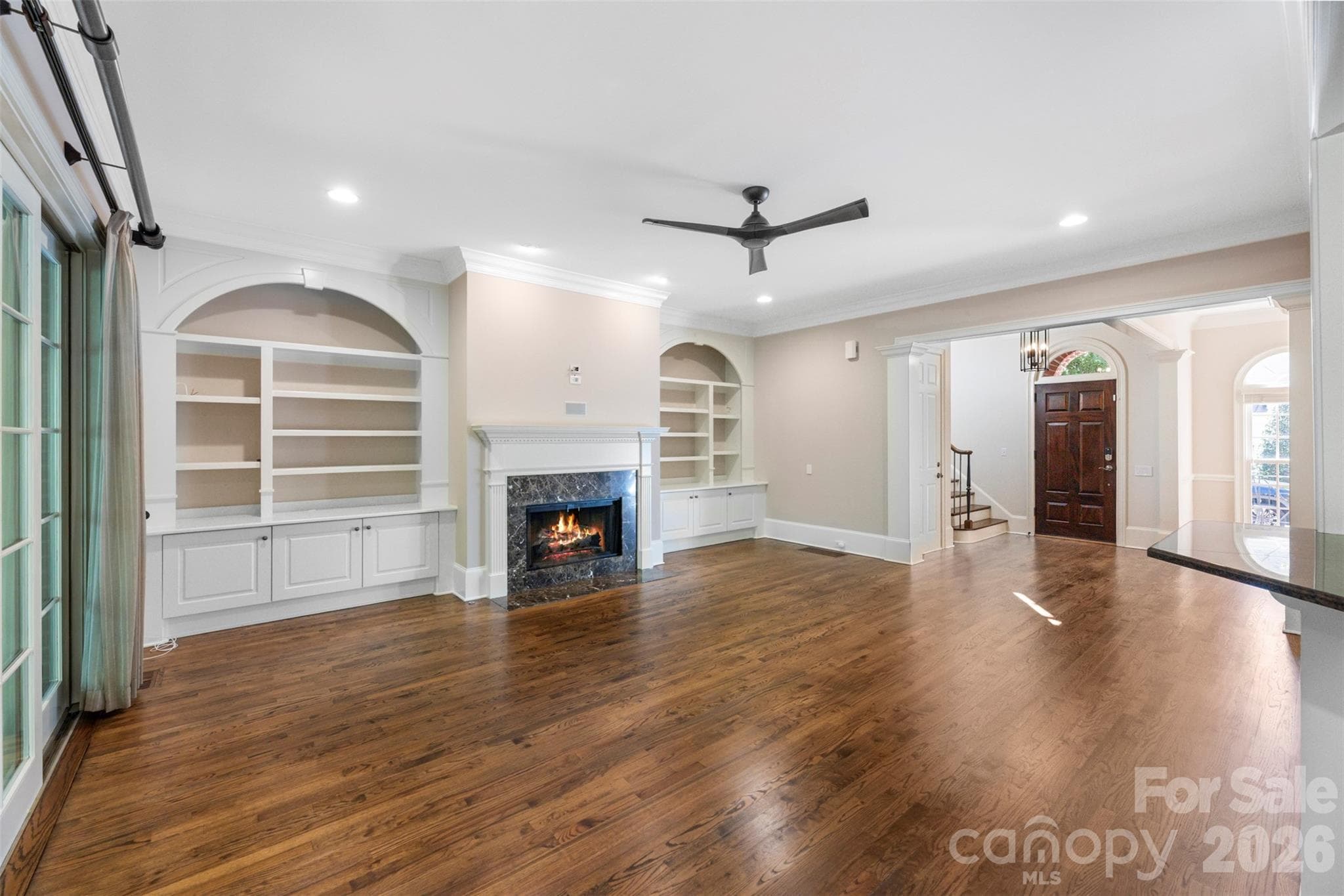 Formal living room with built in bookshelves and gas fireplace. - Charlotte