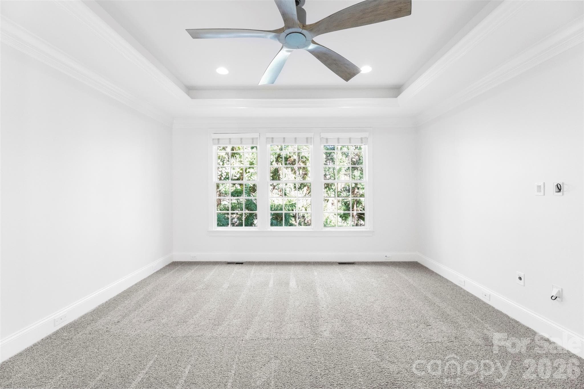 First floor primary bedroom located on backside of the home - Charlotte
