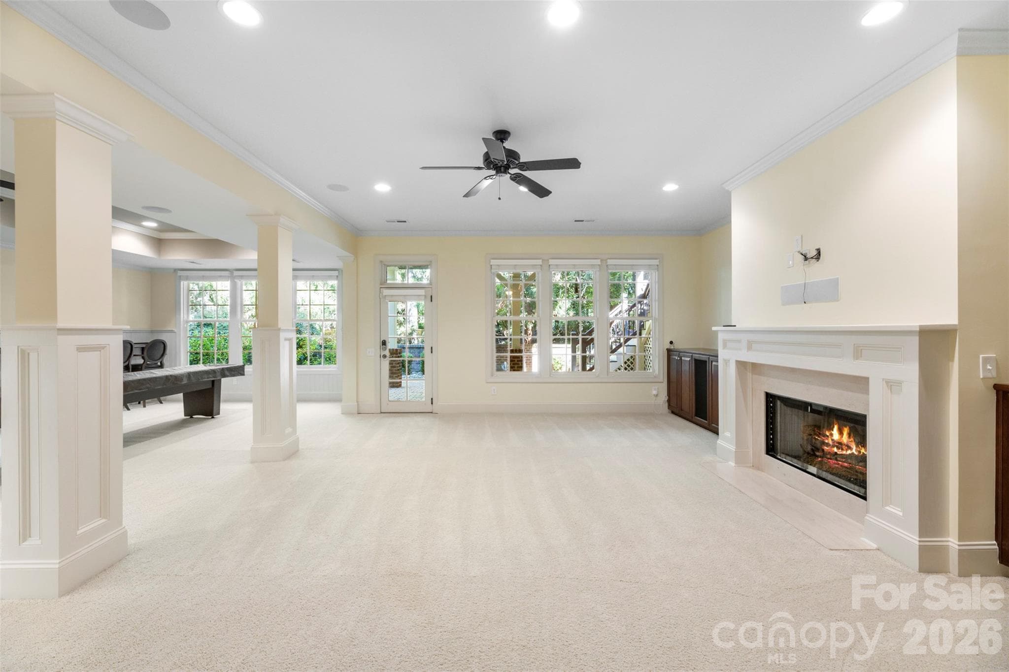 Full basement with gas fireplace and easy access to outside patio. - Charlotte