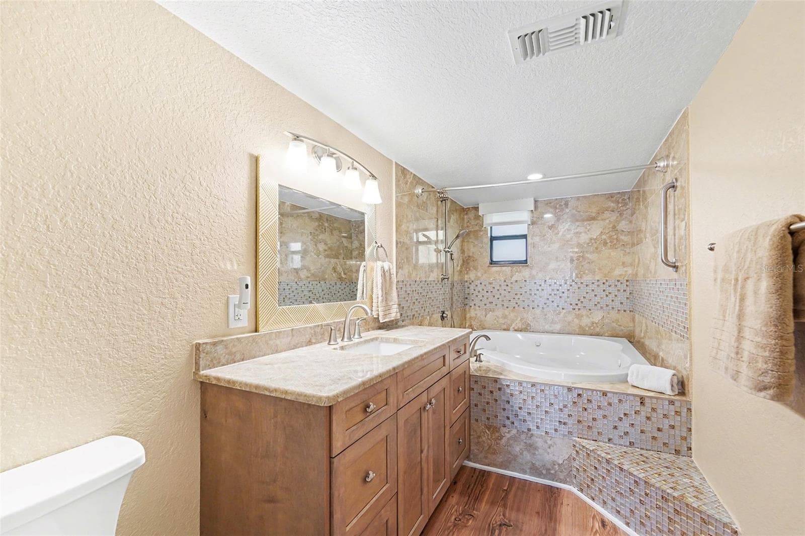 Primary bathroom with jetted tub, new cabinets, and countertop. - 19936 GULF BLVD, INDIAN SHORES