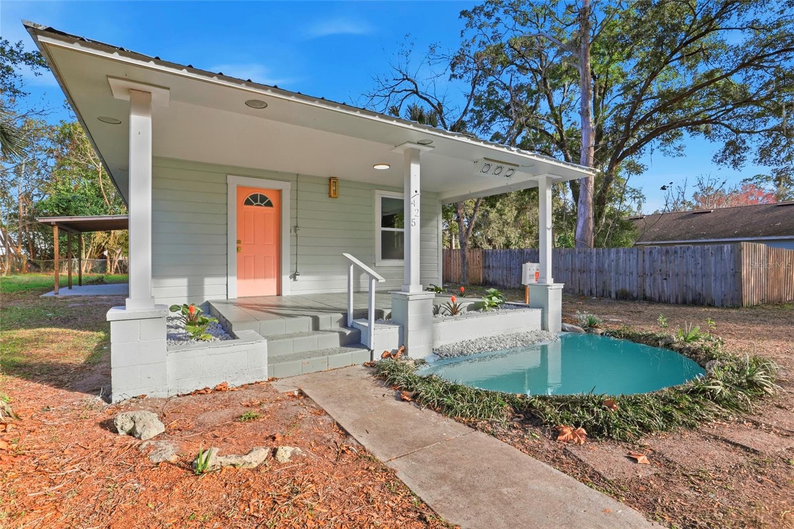 Side view of the front porch and decorative pond - durable metal roof - 425 SE 2ND ST, WILLISTON