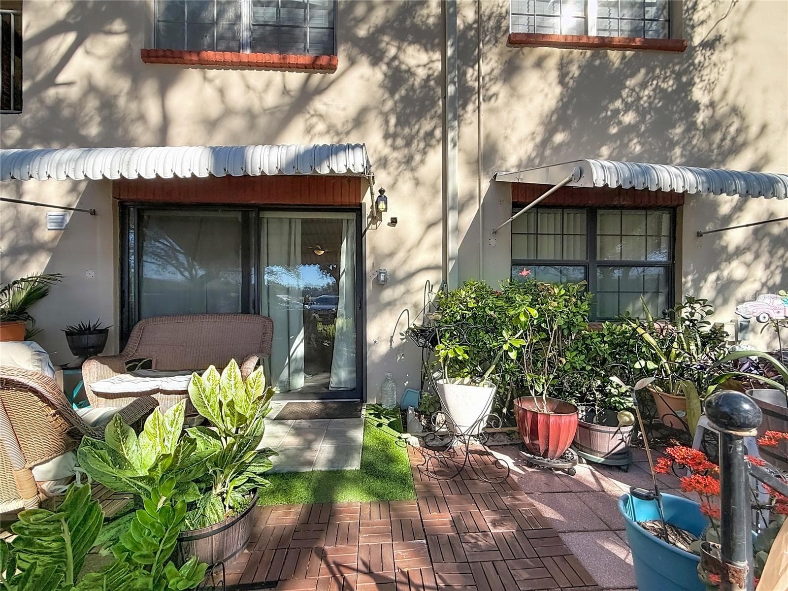 1020 85th Ave N no 119, back patio, sliders to kitchen and window to primary bedroom - 1020 85TH AVE N #119, ST PETERSBURG