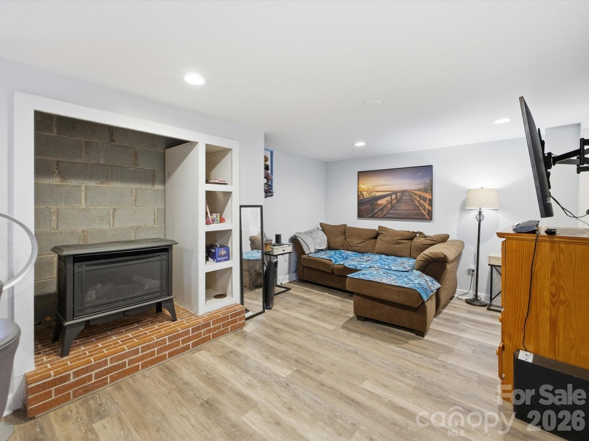 Living room area with gas stove in basement (2nd living area) - 109 Elk Court, Mount Holly