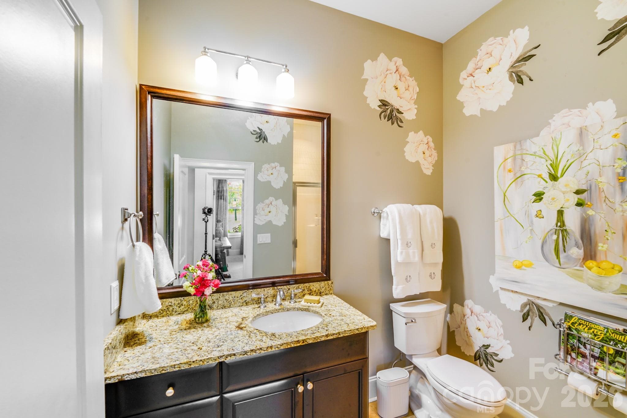 This cheerful and stylish guest bathroom offers granite countertops, under mount sink and rich wood cabinetry - 2702 Arsdale Road, Waxhaw