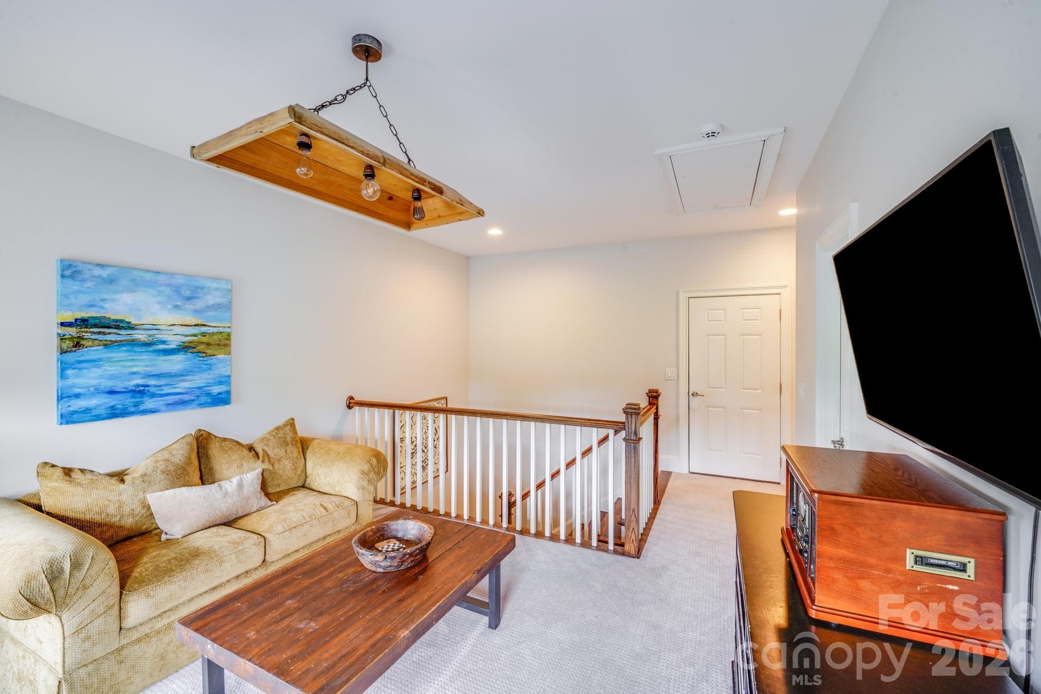 This second view of the loft highlights it's ample room for seating, study, or play, making it a great option for a teen hangout, home office, or secondary living area - 2702 Arsdale Road, Waxhaw