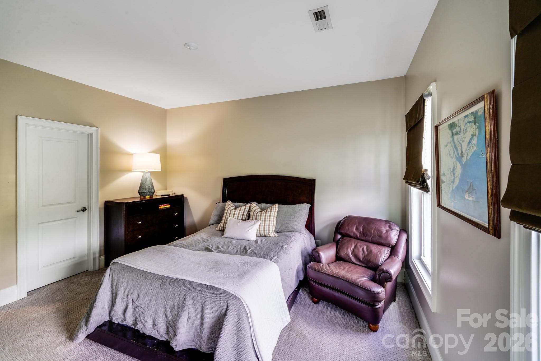 This comfortable secondary upstairs bedroom offers space for a full or queen bed, dresser, and additional seating - 2702 Arsdale Road, Waxhaw