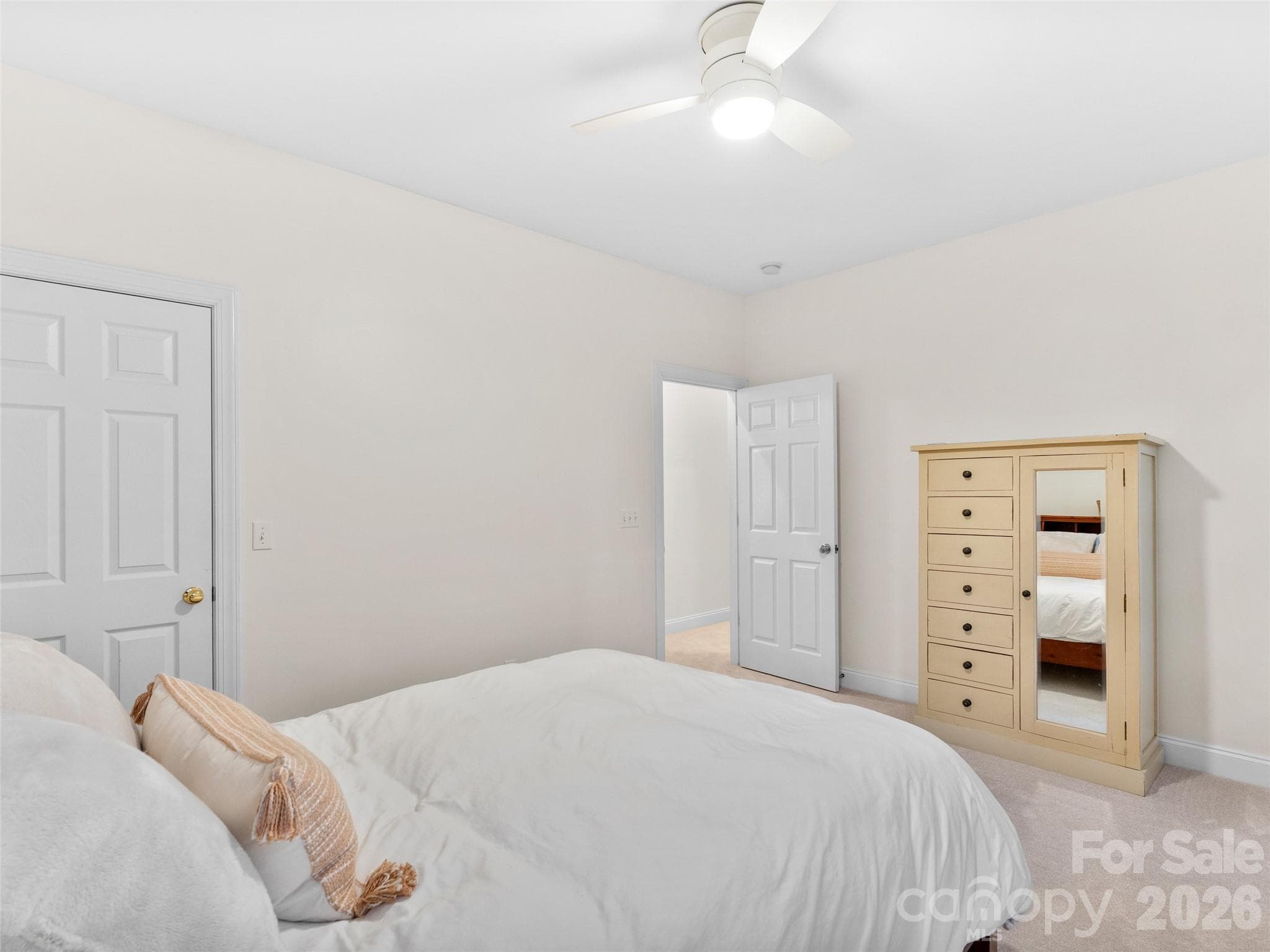 Upper level bedroom features plush carpeting and closet, offering comfort and functionality. - Asheville