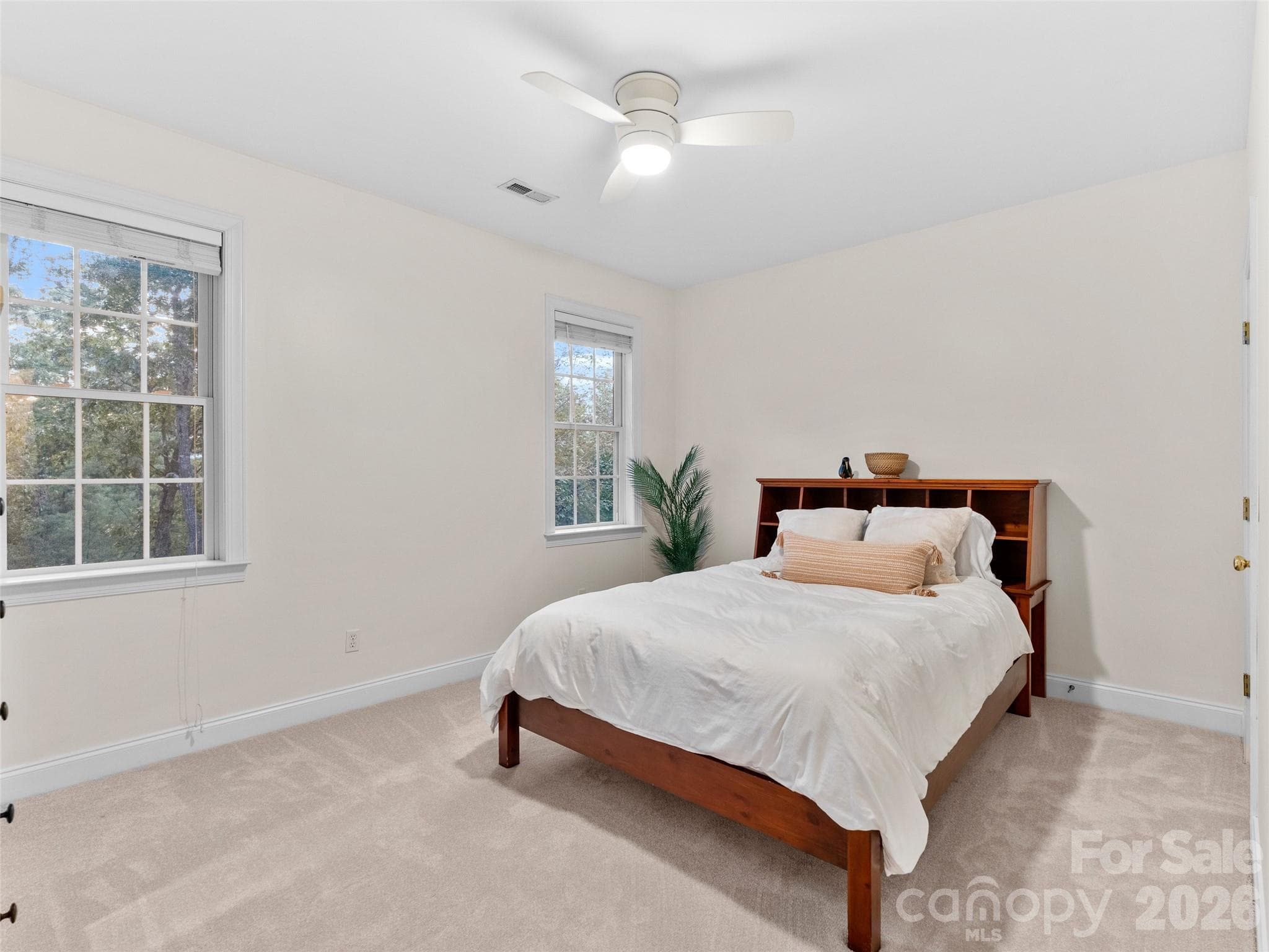 Upper level bedroom with carpet and closet. - Asheville