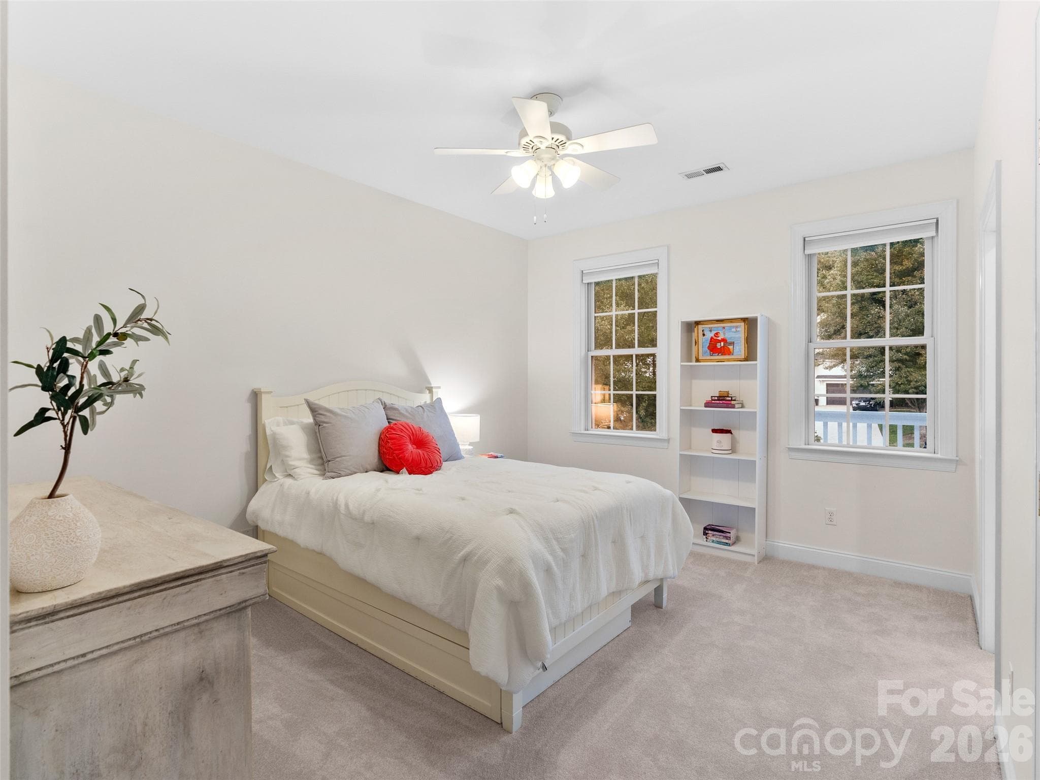 This bedroom features soft carpeting and direct access to a shared bath, offering comfort and easy convenience for family or guests. - Asheville