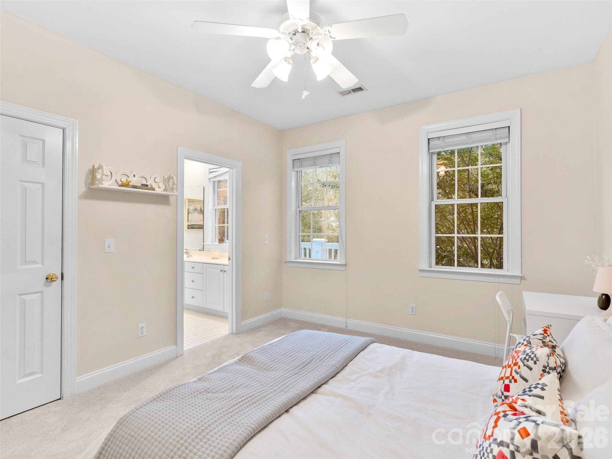 This upper level bedroom features a walk-in closet, ample windows, and direct access to the shared bathroom-perfect for family or guests. - Asheville
