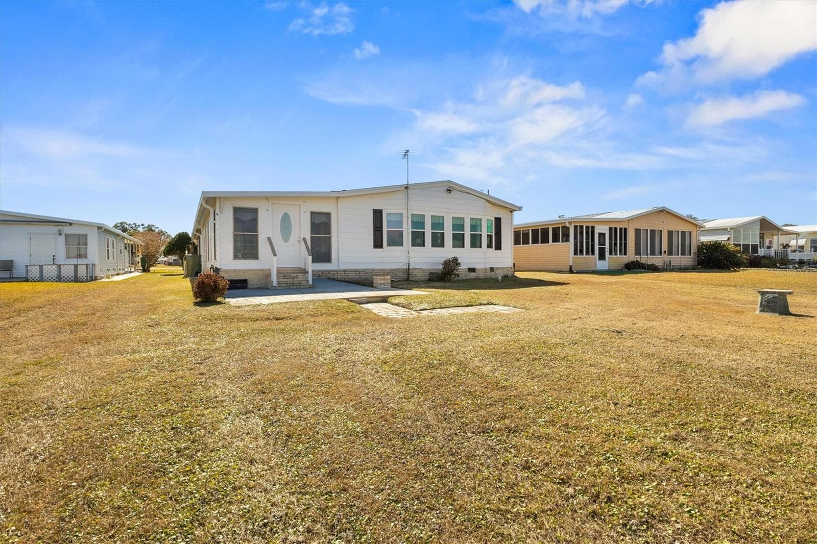 Back Exterior - Open Paved Patio - 6825 S LAKE HENRY DR NE, WINTER HAVEN