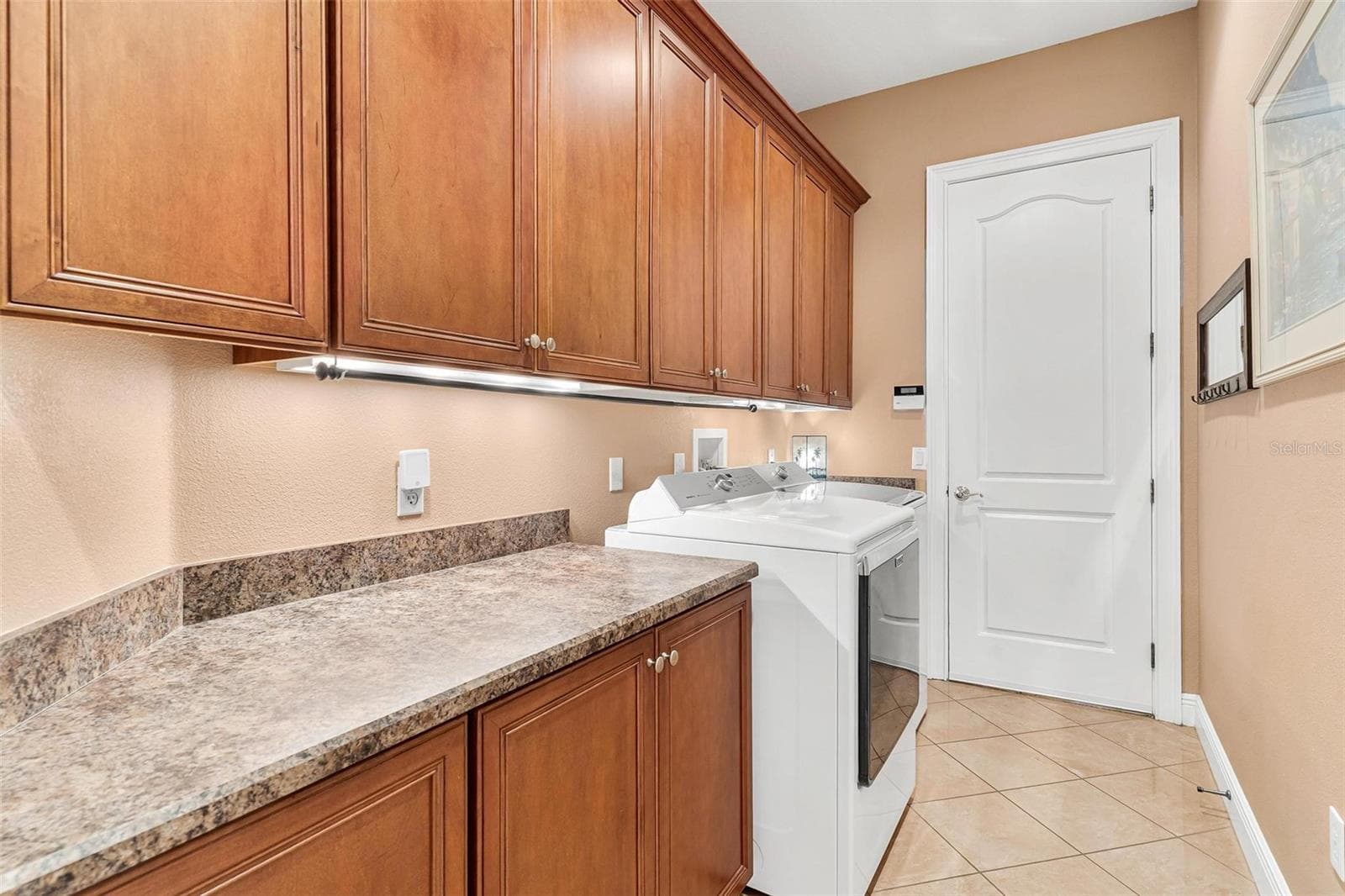 Inside Laundry room with lots of cabinets and folding counter! - 26309 SAN GABRIEL, HOWEY IN THE HILLS