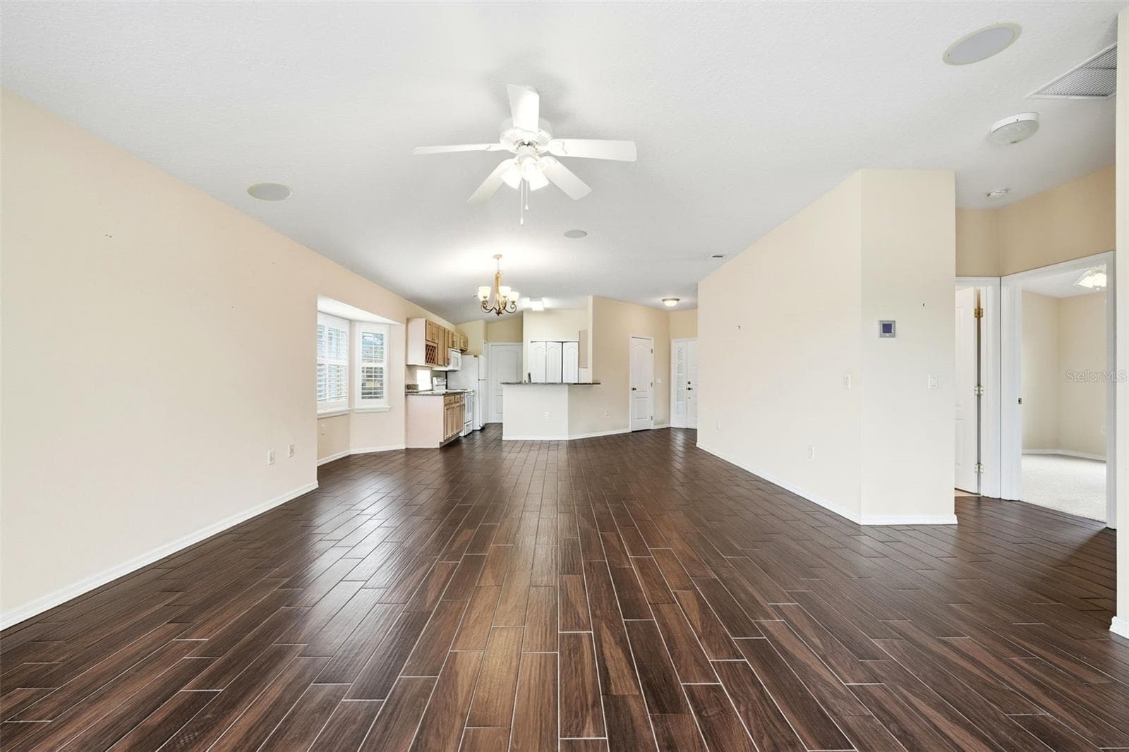 View from lanai into great room, dining, kitchen areas and hallway to Bedroom 2 and Guest Bath! - 2311 N ANDREA PT, LECANTO