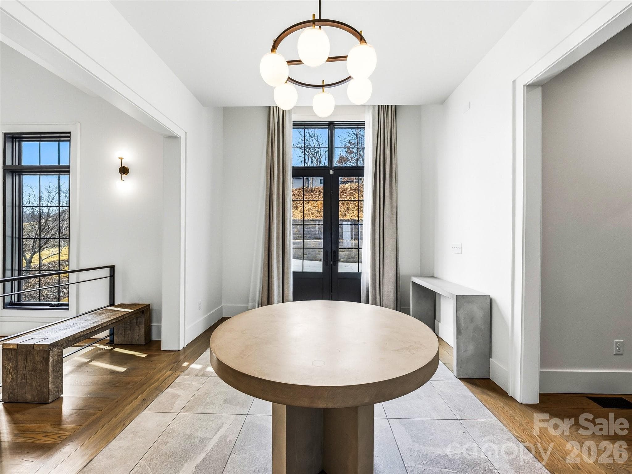 Bright foyer with tall ceilings, modern lighting, and expansive windows filling the space with natural light - 241 Tower Circle, Hendersonville