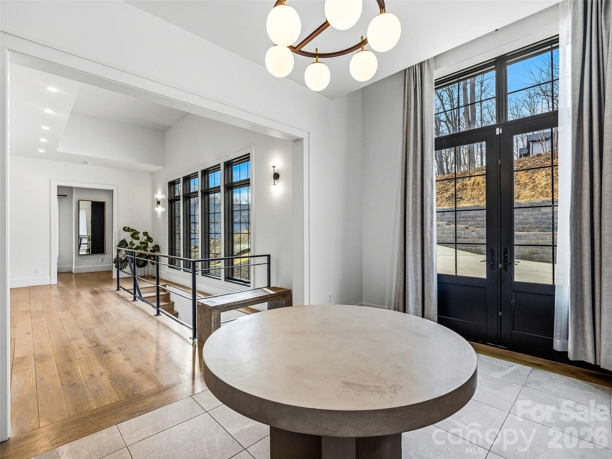 Spacious entry with statement lighting, clean lines, and seamless flow into the main living spaces - 241 Tower Circle, Hendersonville