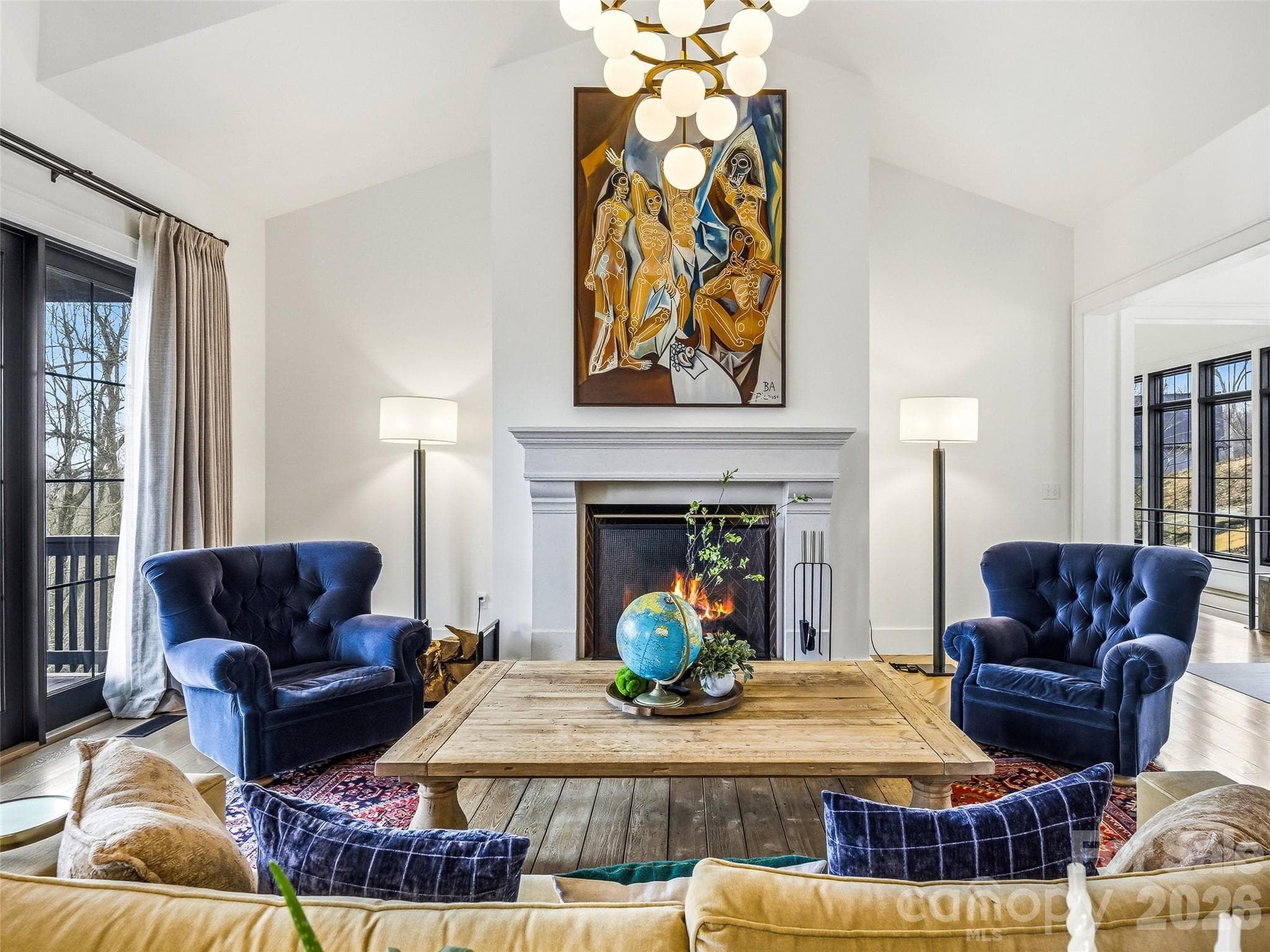 Great room with vaulted ceilings, statement chandelier, and fireplace centerpiece - 241 Tower Circle, Hendersonville
