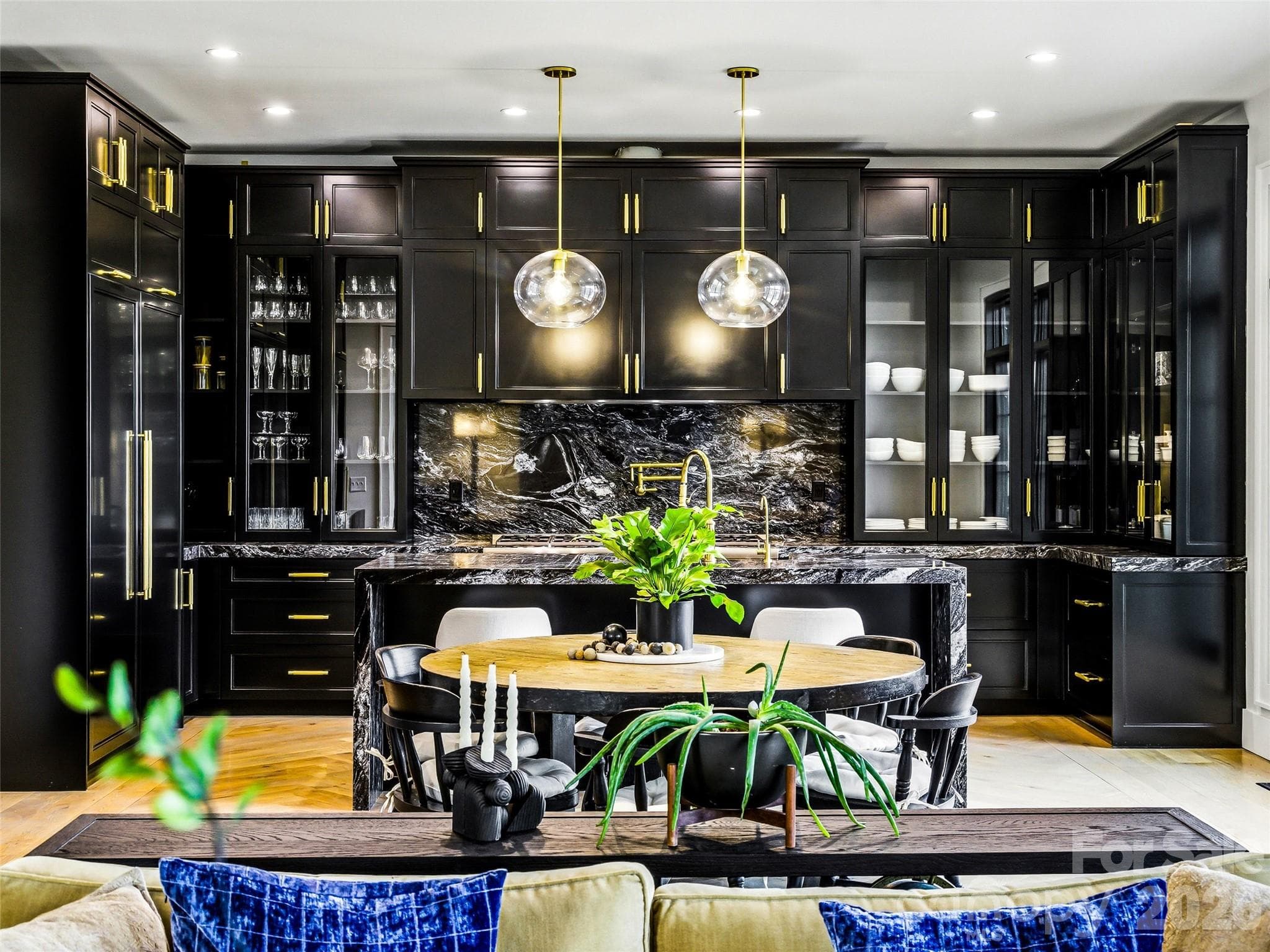 Designer kitchen with custom black cabinetry, granite backsplash, and statement lighting - 241 Tower Circle, Hendersonville