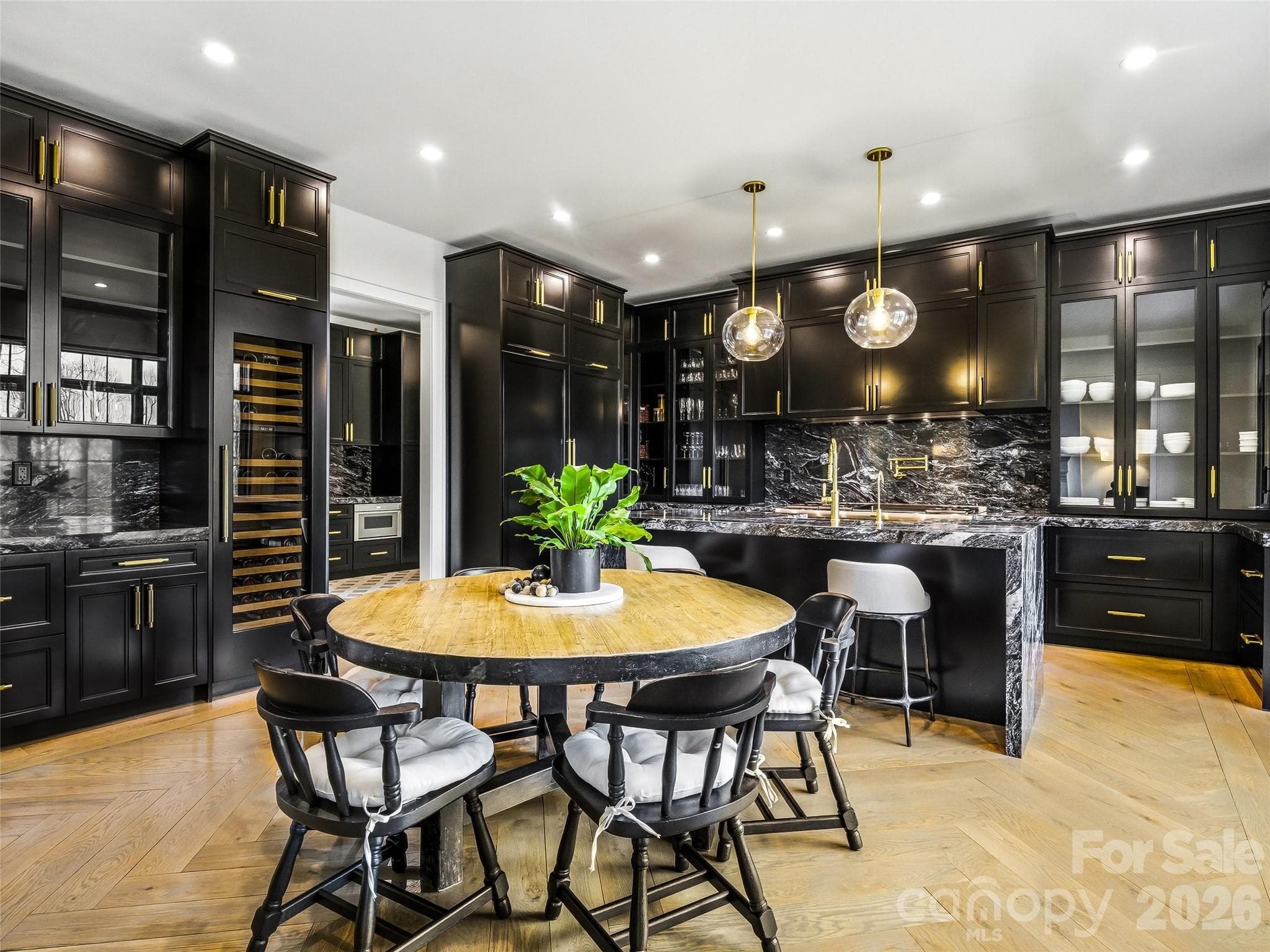 Spacious island and dining area with built-in cabinetry and abundant natural light - 241 Tower Circle, Hendersonville