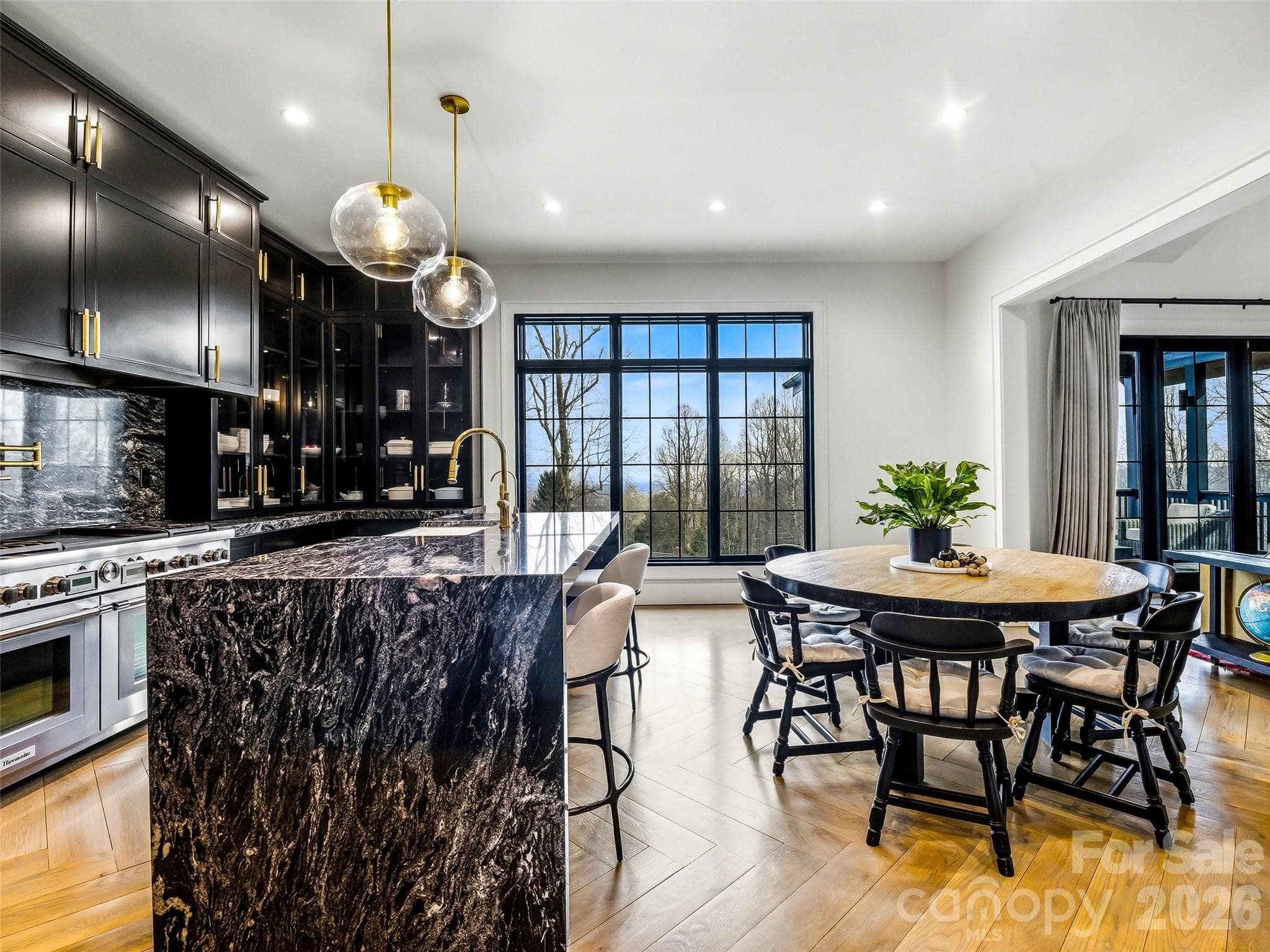 Open kitchen layout with oversized island and seamless connection to the living areas - 241 Tower Circle, Hendersonville
