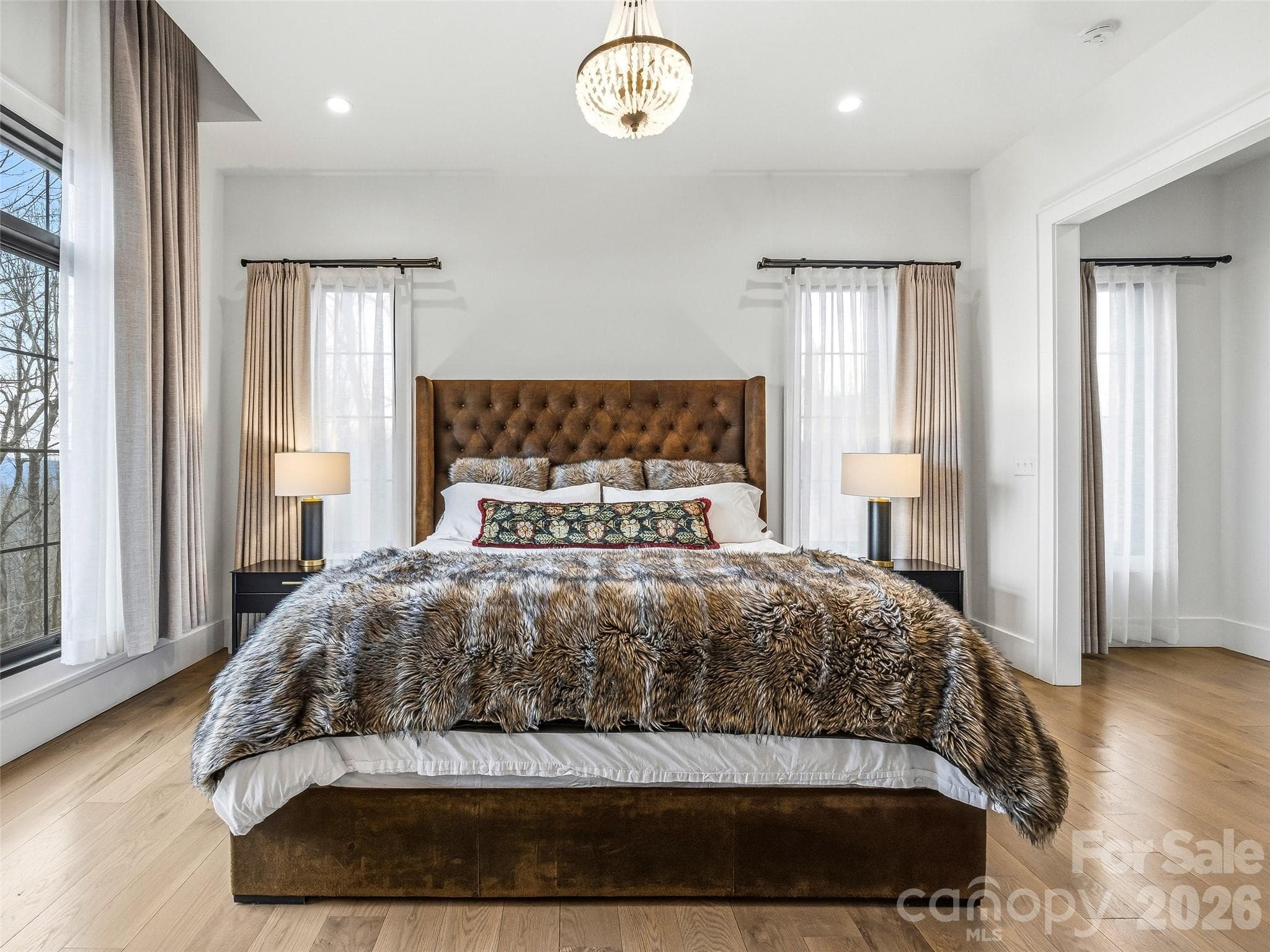 Spacious primary bedroom with vaulted ceilings and hardwood floors - 241 Tower Circle, Hendersonville